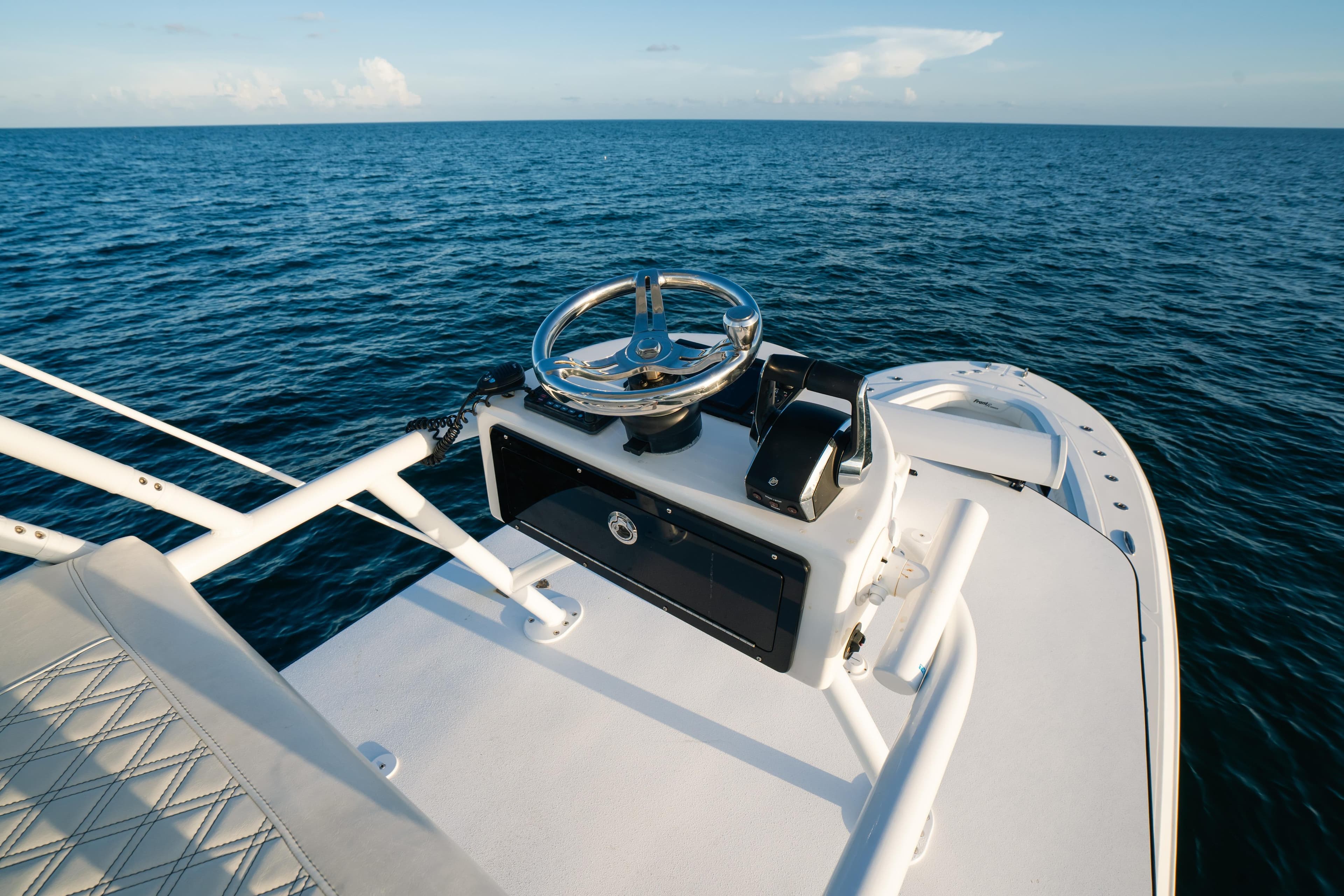 2023 Front Runner 36 Center Console boat on open sea, featuring sleek helm design.