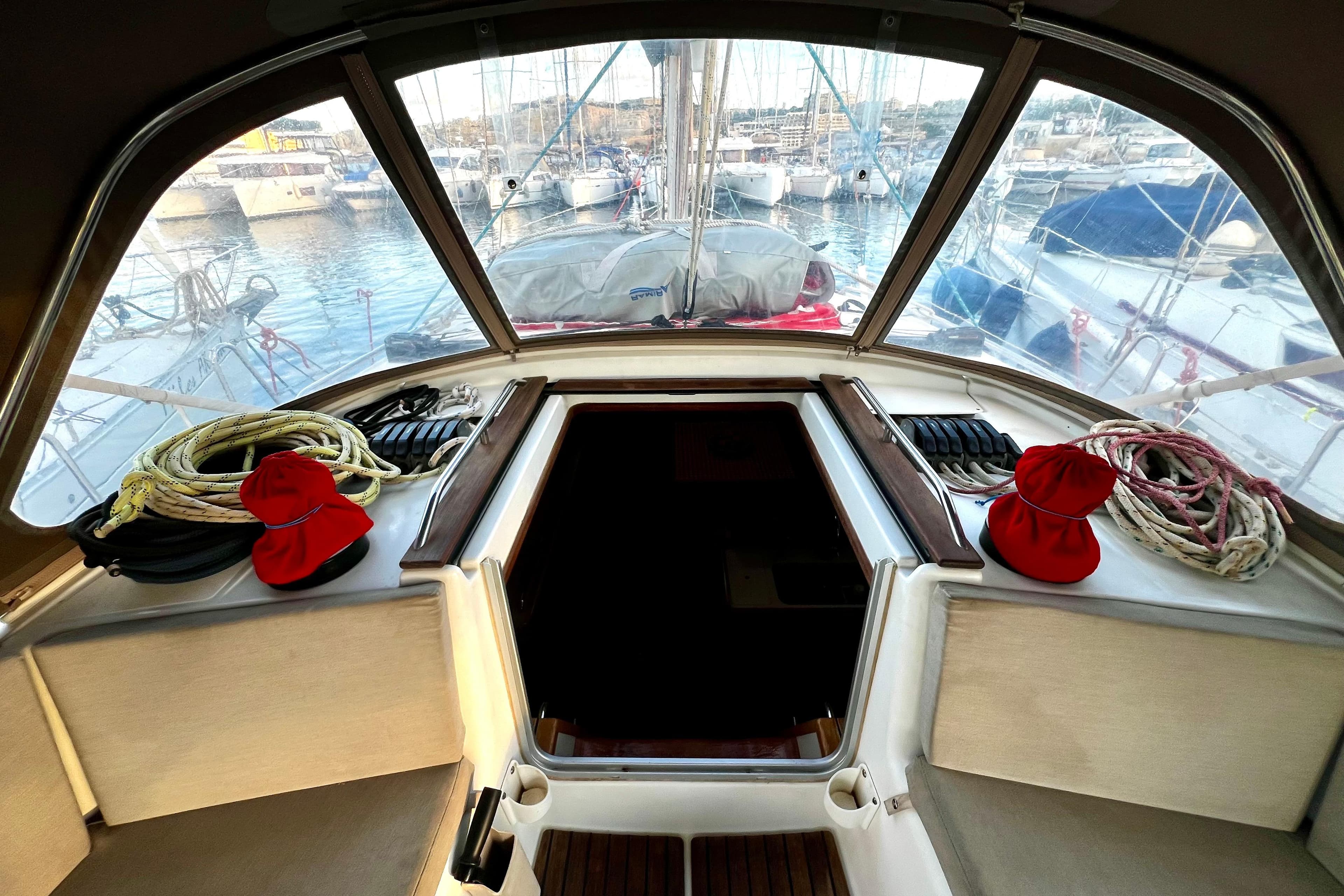 Interior view of 2008 Jeanneau Sun Odyssey 45 DS sailboat cockpit with ropes and red caps.