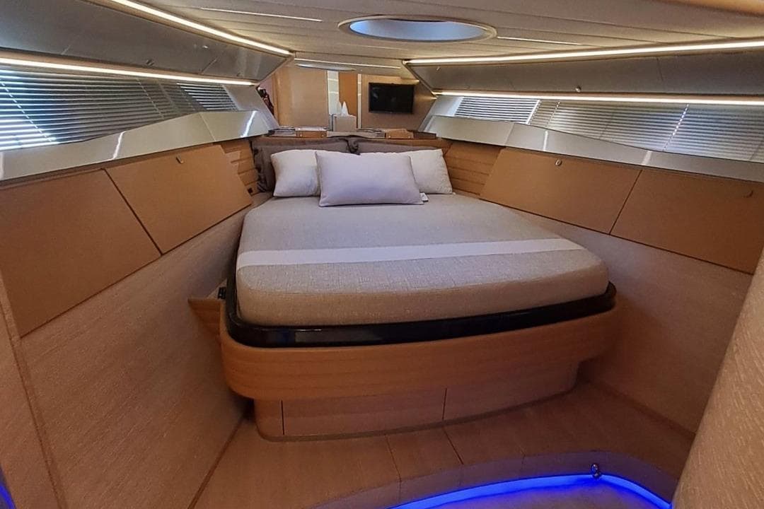 Luxurious interior of 2010 Otam 58 yacht with modern bed and ambient lighting.