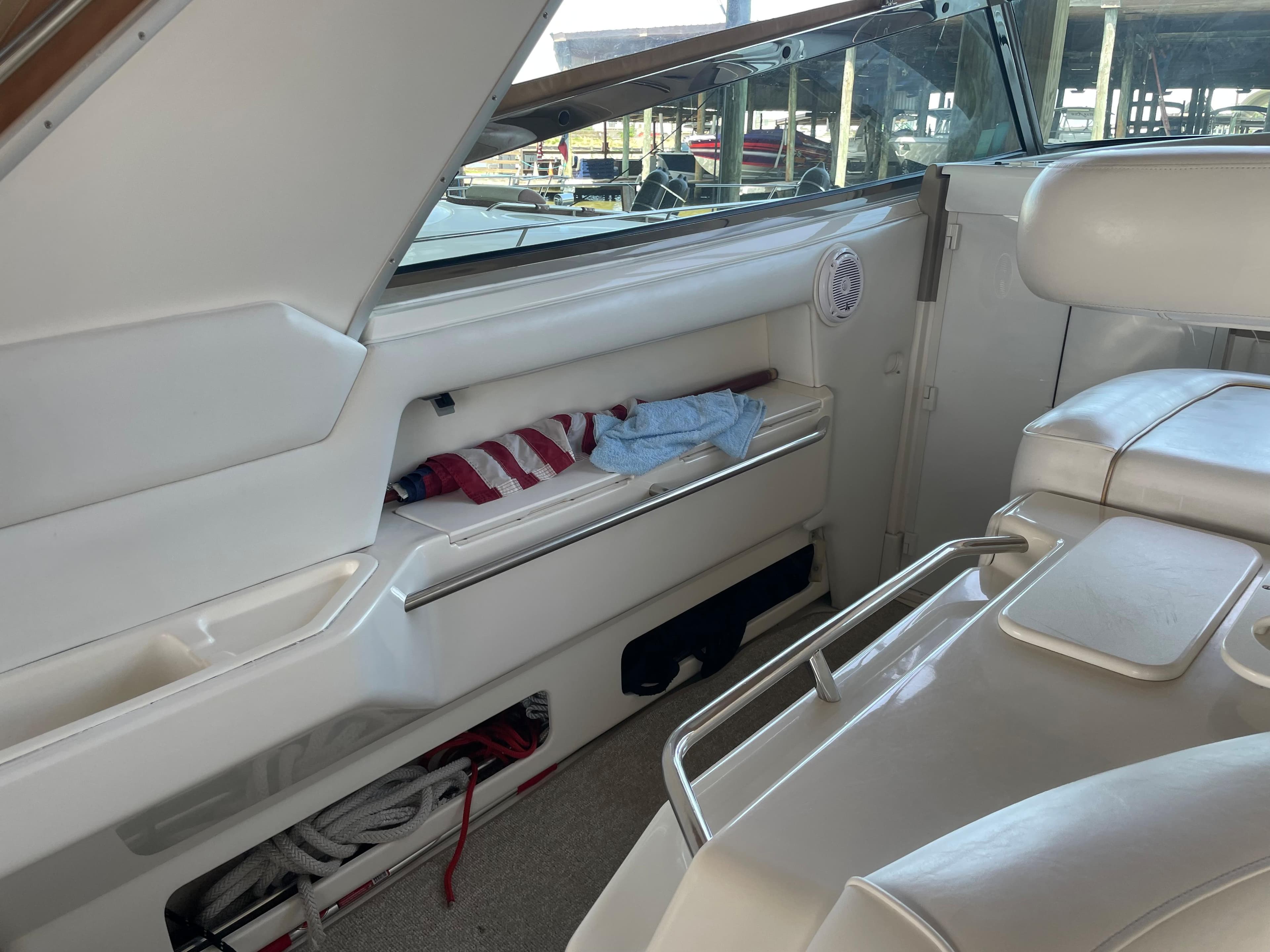 Interior of 1996 Sea Ray 500 Sundancer yacht with white seating and storage compartments.