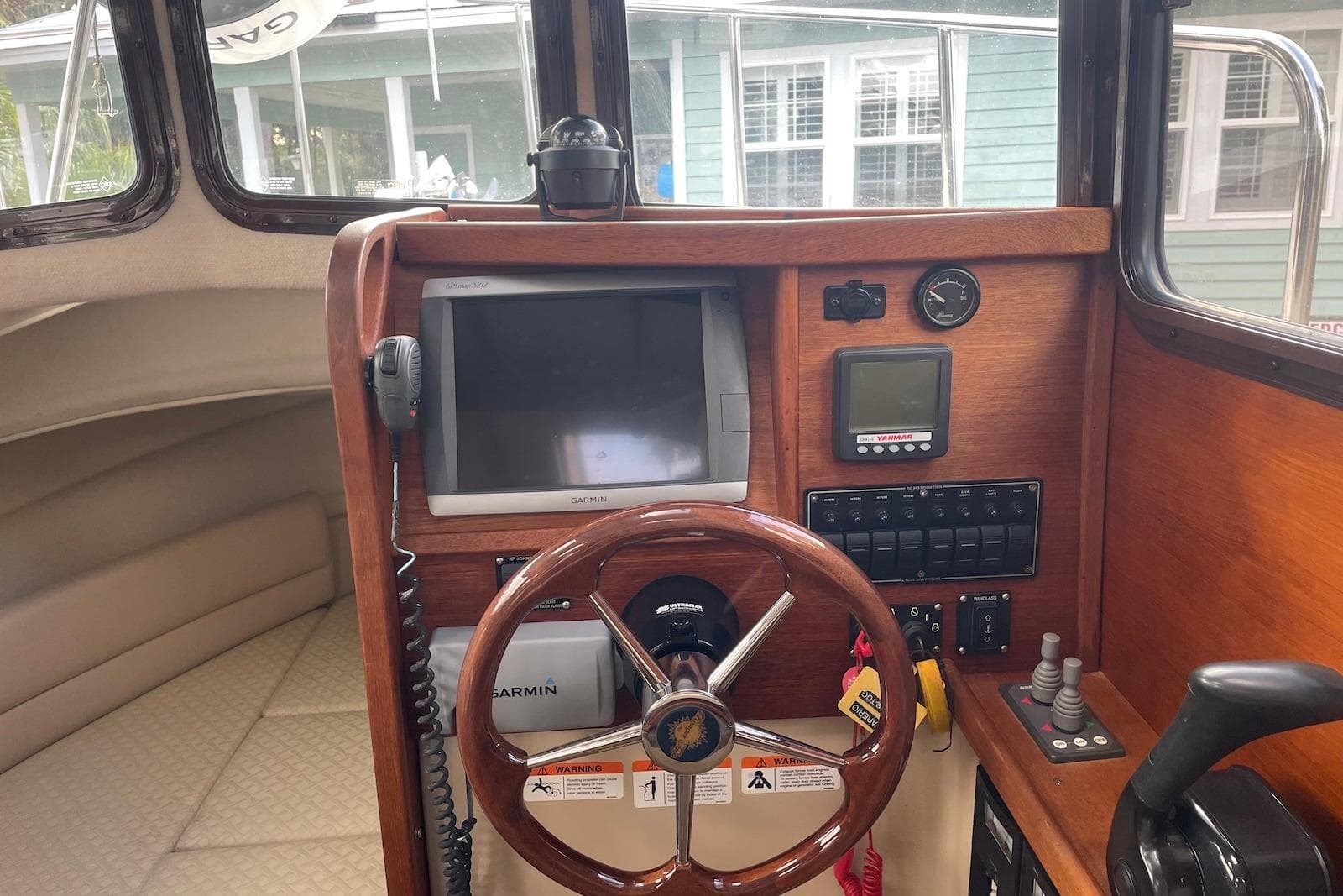 2012 Ranger Tugs R-27 helm with Garmin navigation and wood finish.
