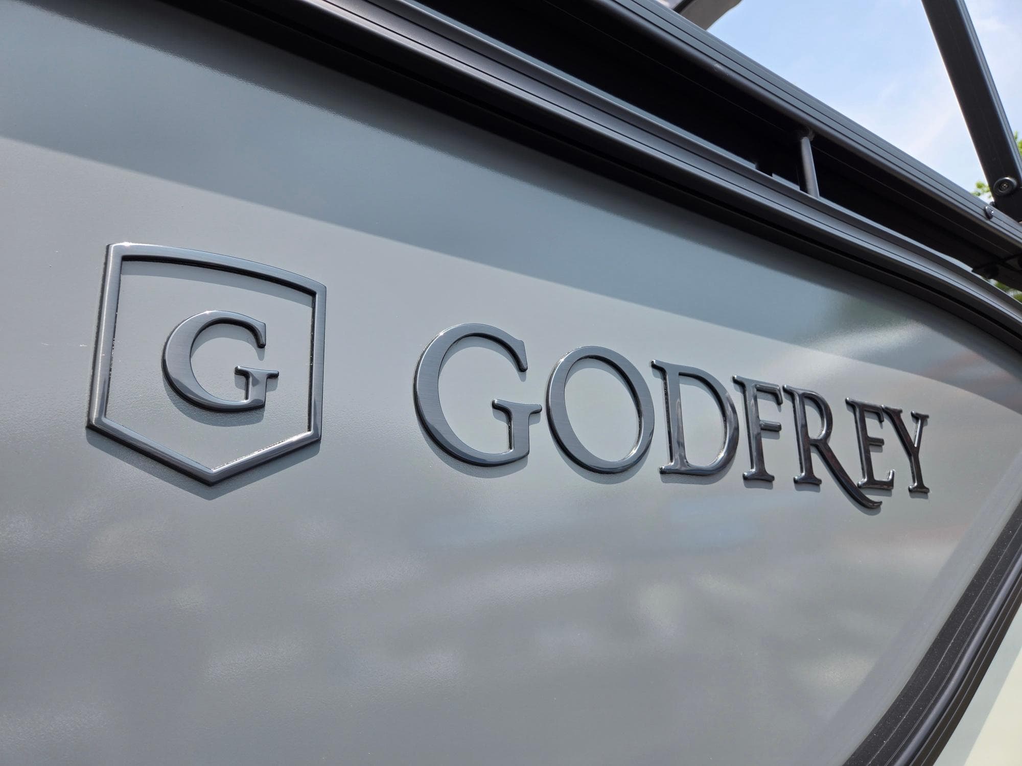 2026 Godfrey Sweetwater 2286 QS boat logo on gray surface.
