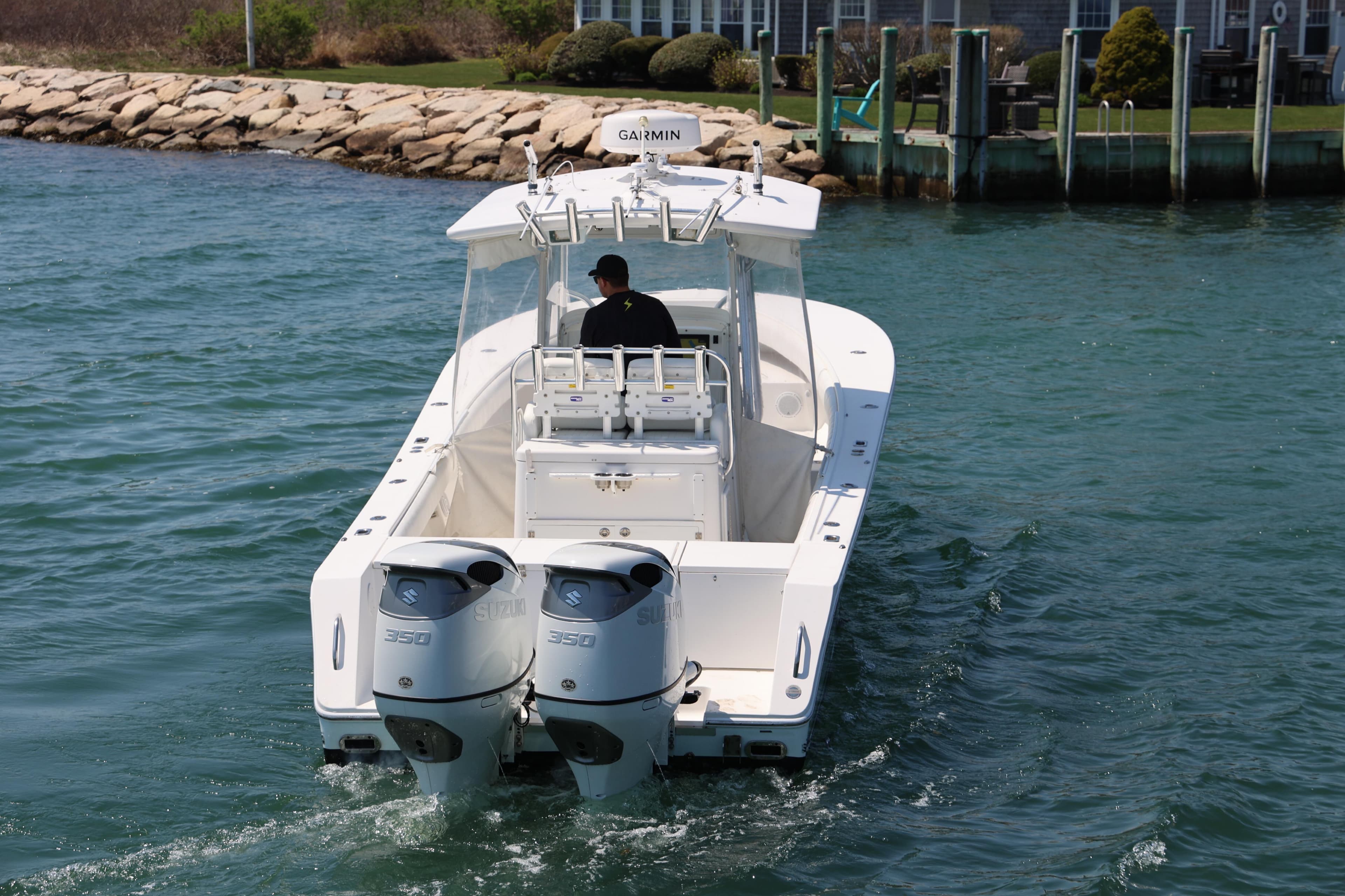 2009 Regulator 32 Forward Seating boat with dual Suzuki 350 engines on water.