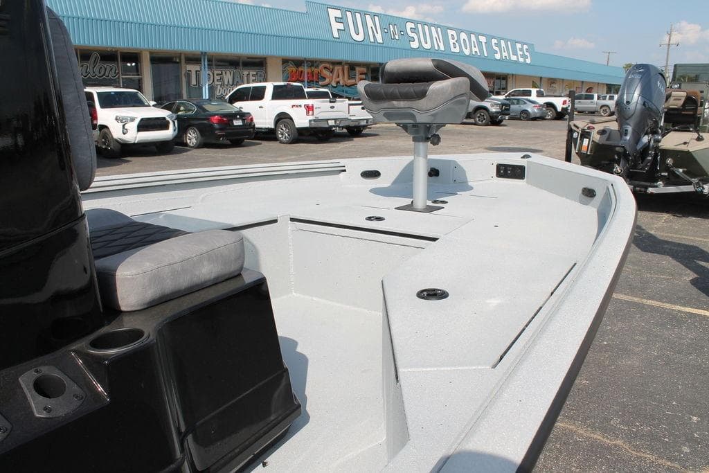 2026 Excel Bay Pro Elite 203 boat at dealership, showcasing spacious deck and seating.