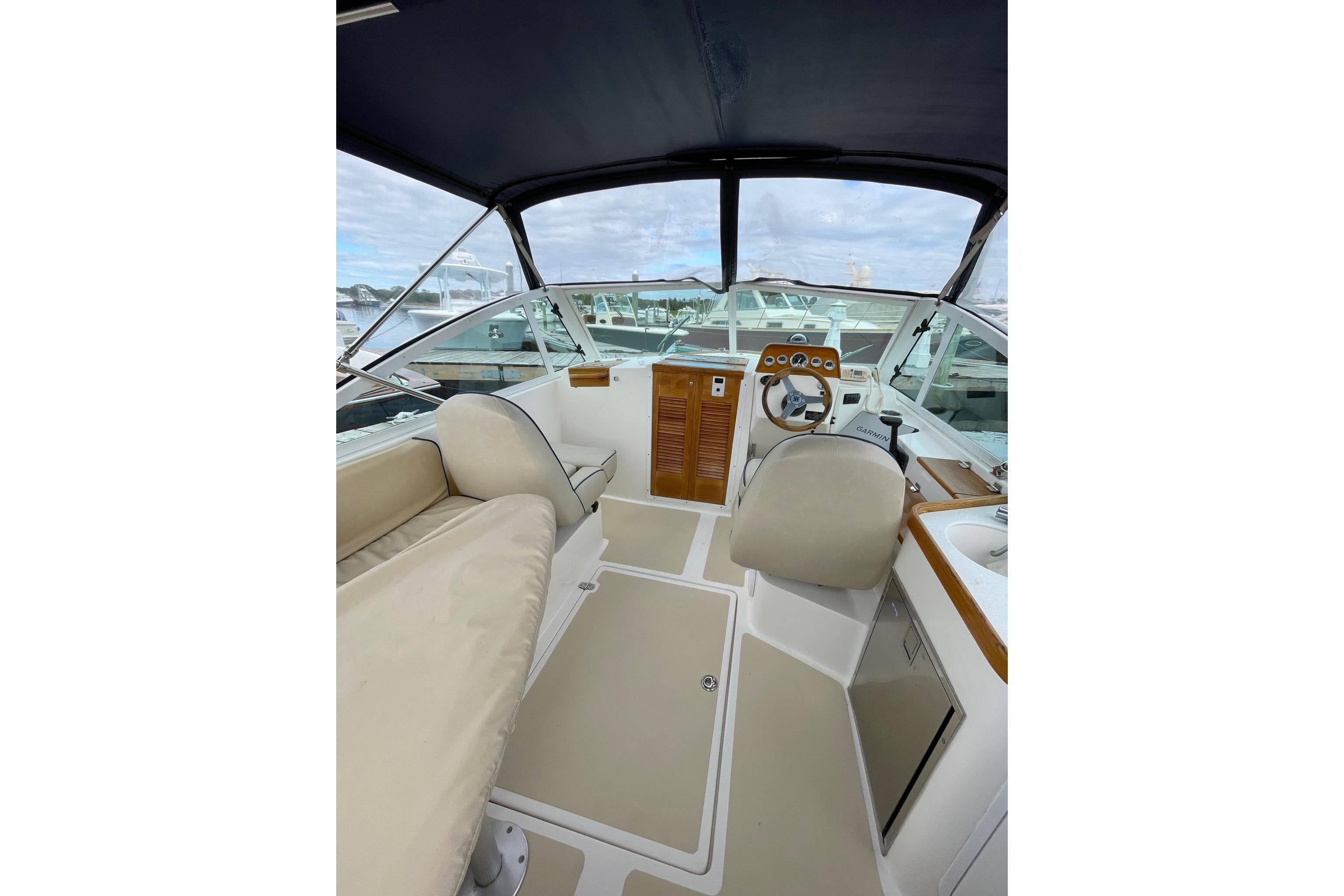 2005 Hunt Yachts Harrier 25 interior with helm, seating, and canopy.