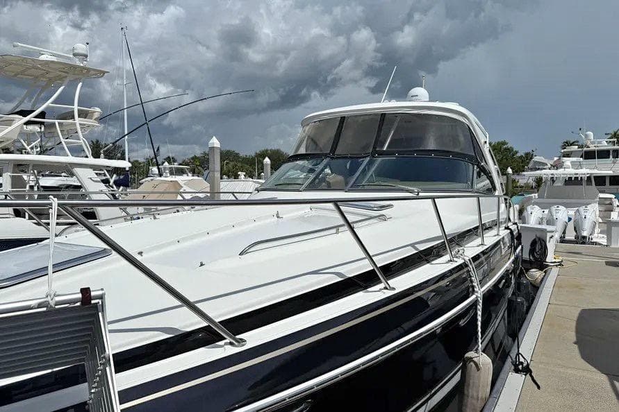 2016 Formula 37 Performance Cruiser docked at marina under cloudy sky.