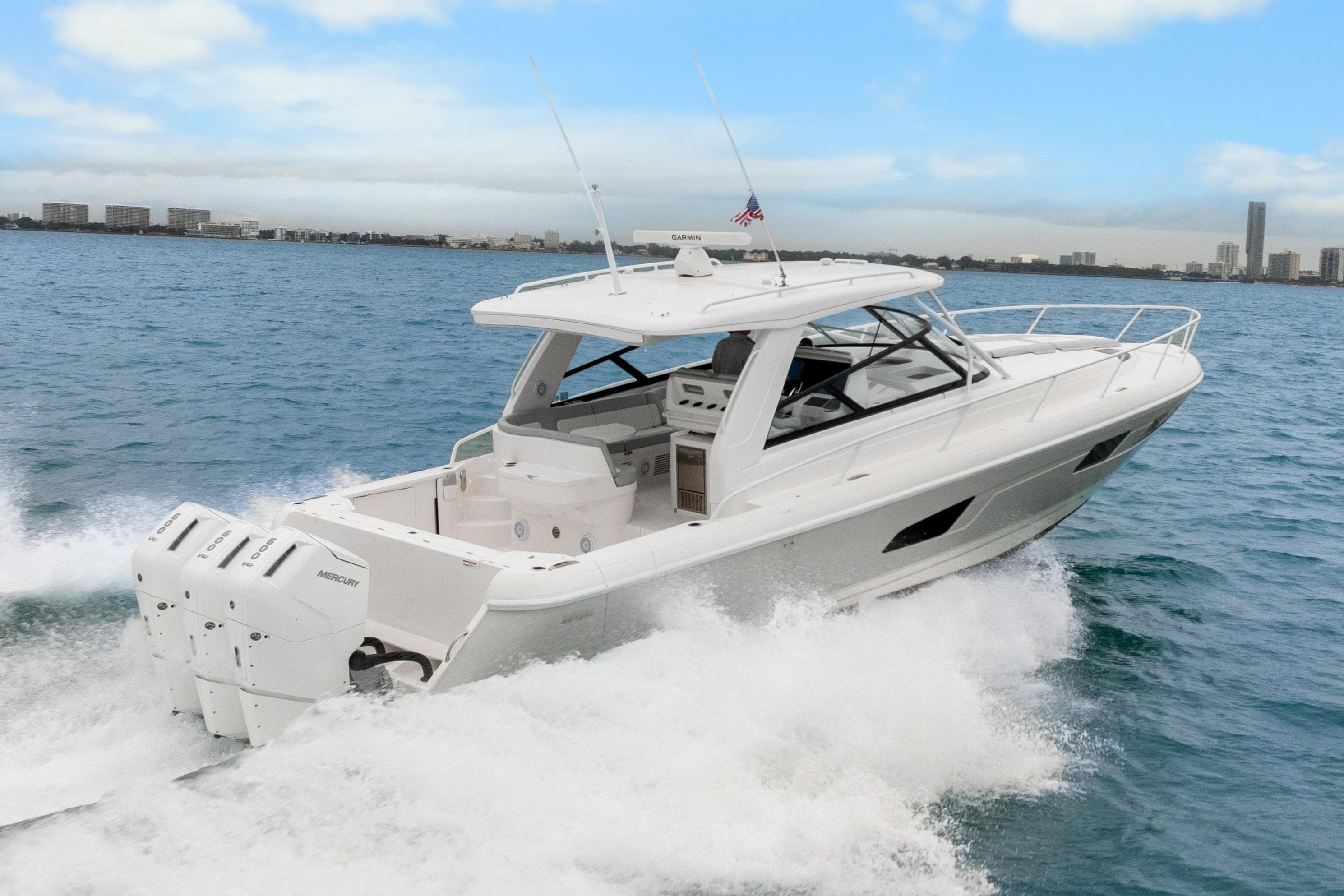 2024 Intrepid 477 Evolution yacht cruising on open water, showcasing sleek design and powerful engines.