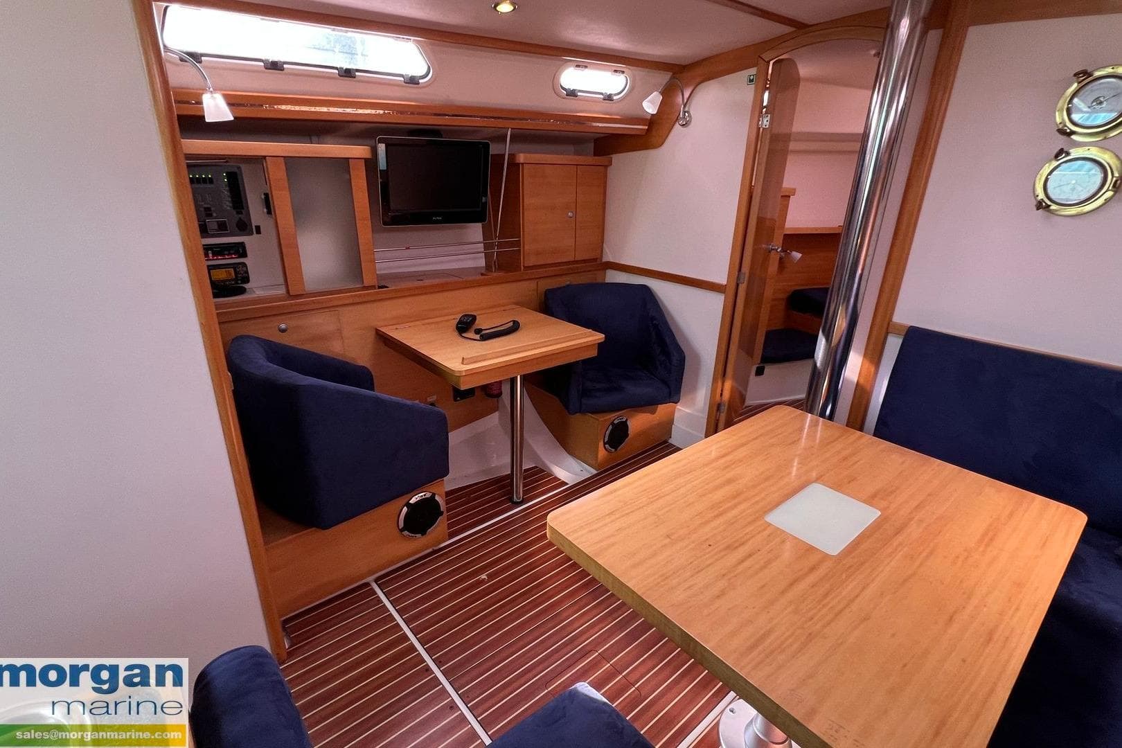 Interior of 2007 Hanse 400 yacht with wooden furnishings and blue seating.