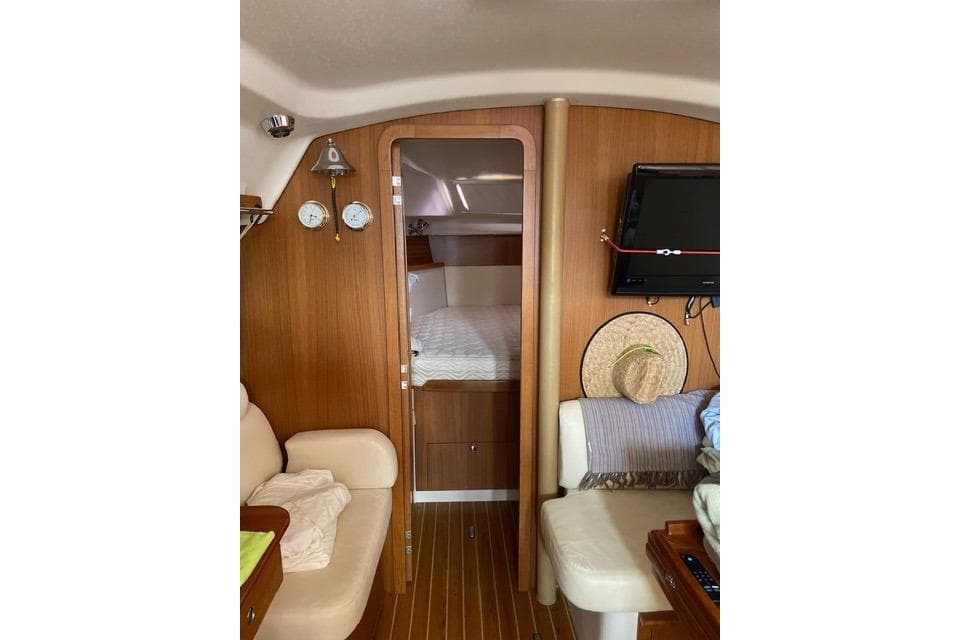 Interior of 2011 Catalina 355 sailboat with cozy cabin and wooden finish.