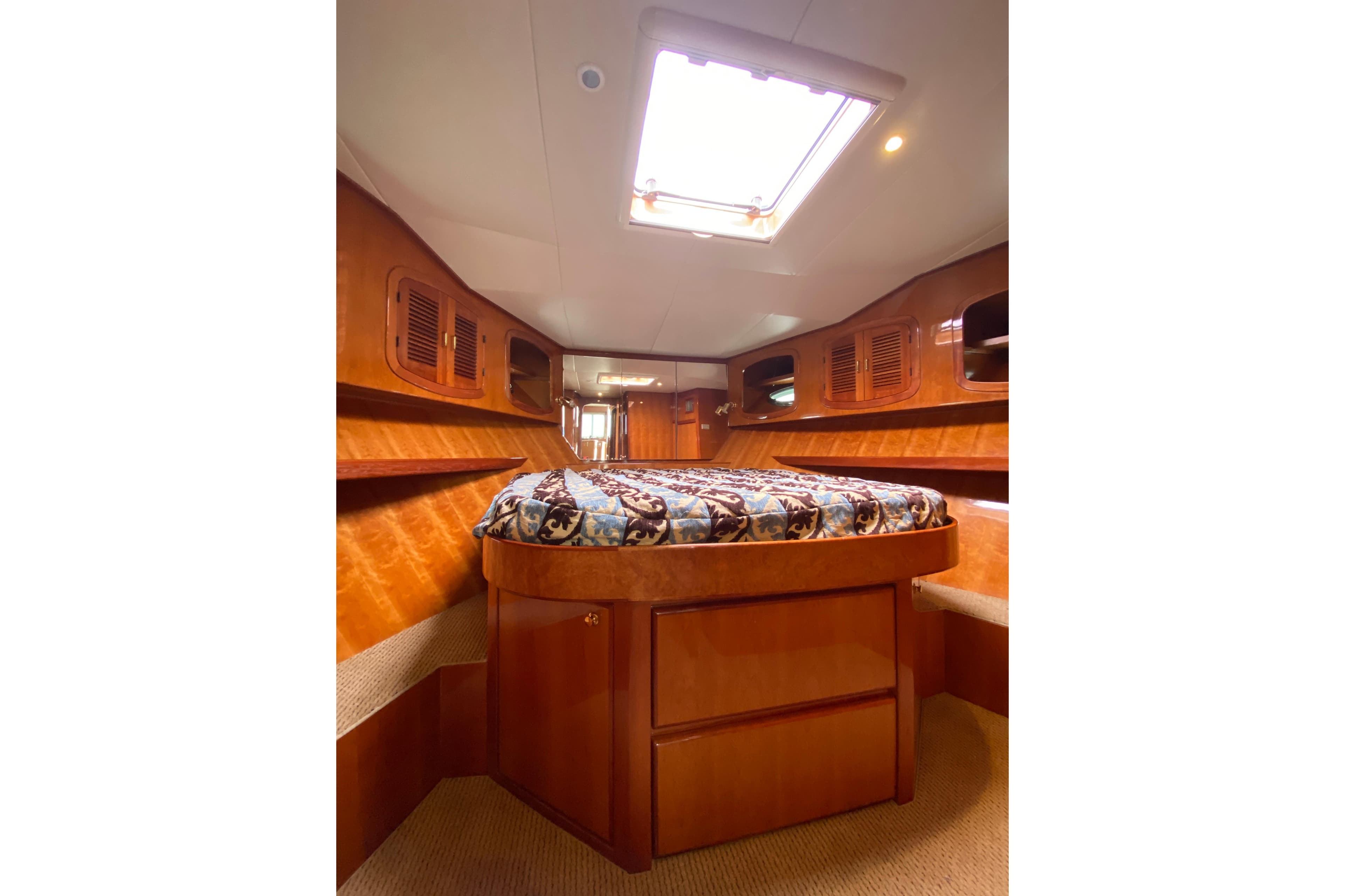 Luxurious cabin interior of 2012 Mikelson 43 Sportfisher with elegant wood finish.