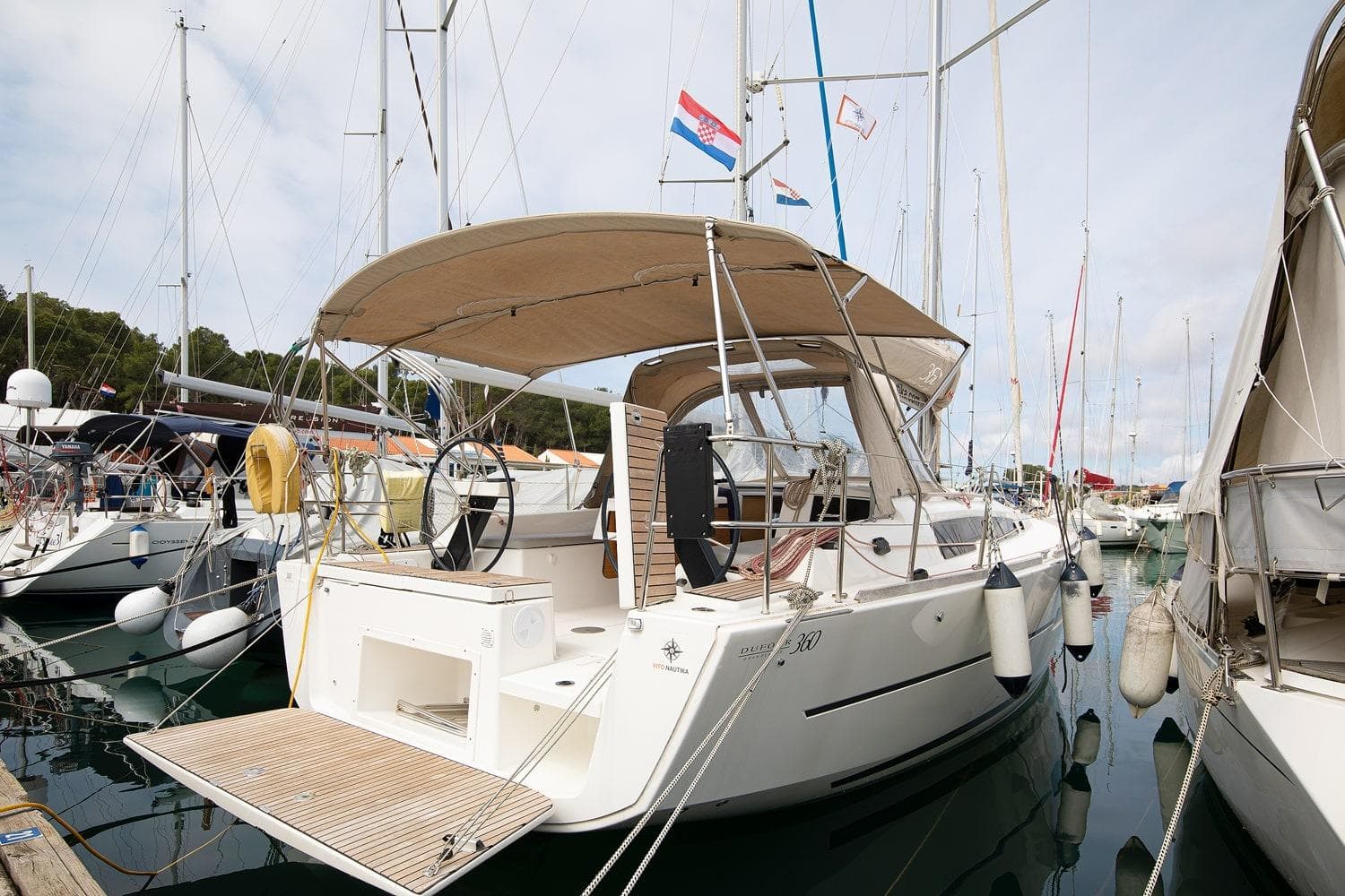 2019 Dufour 360 Grand Large yacht docked in a marina.