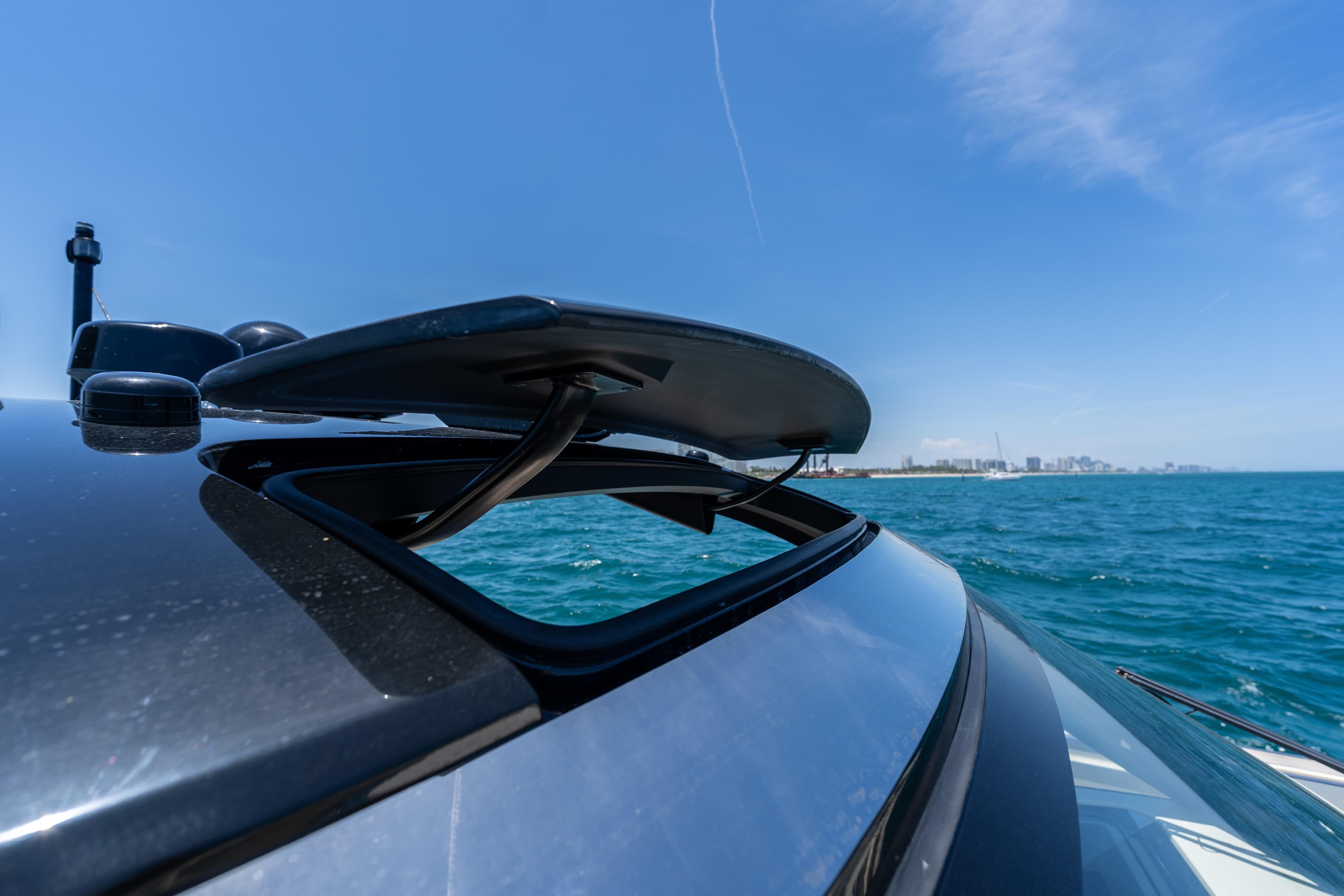 2024 Invictus 460 yacht with open sunroof on a sunny day at sea.