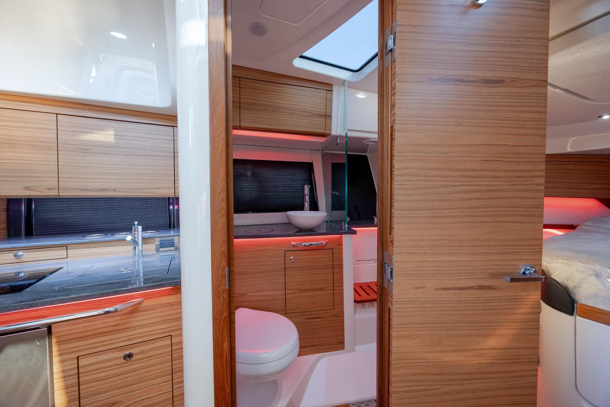 Luxurious interior of 2021 Boston Whaler 405 Conquest with modern wood finishes and ambient lighting.