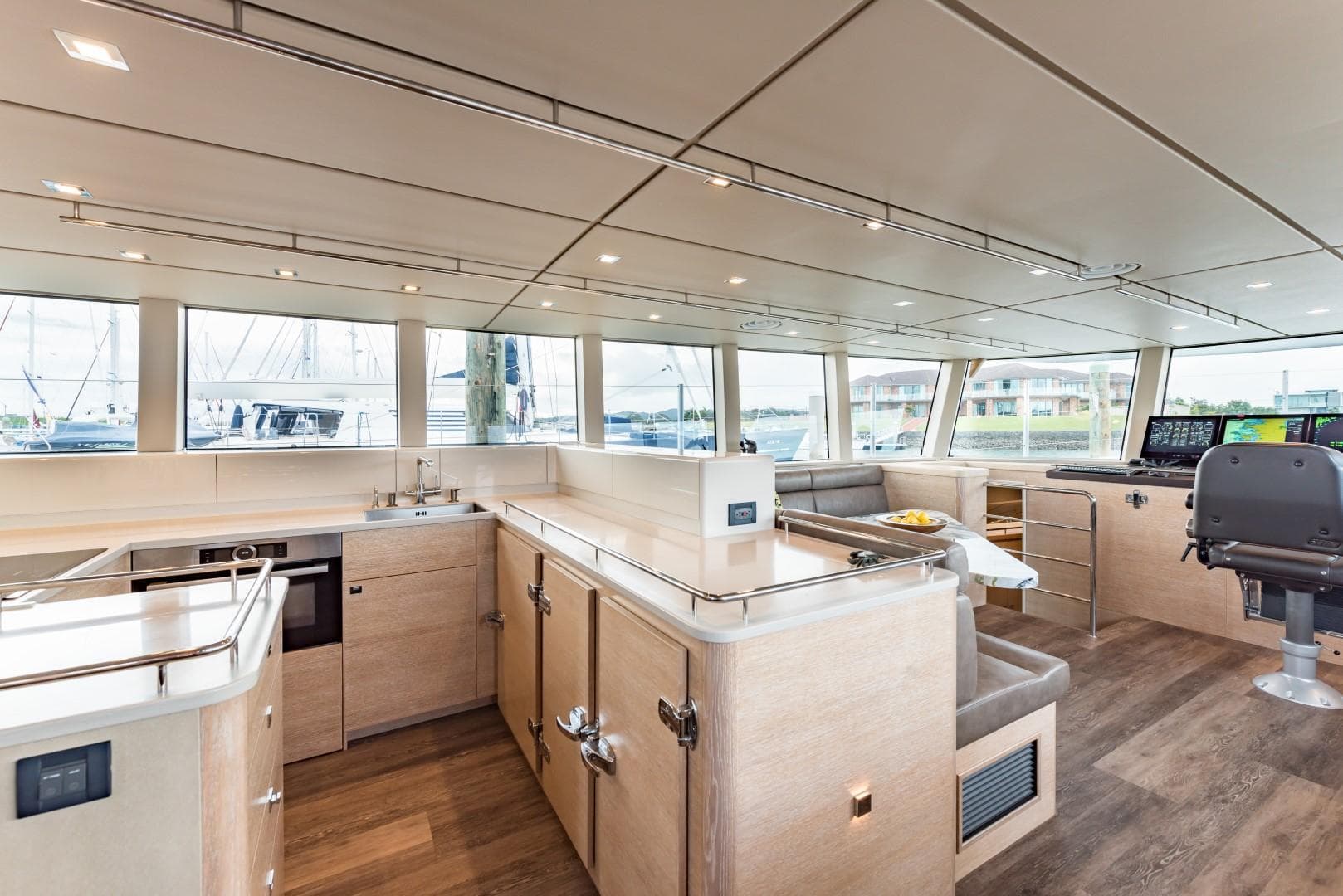 Spacious interior of 2018 Circa Marine FPB 70 yacht with modern kitchen and seating area.