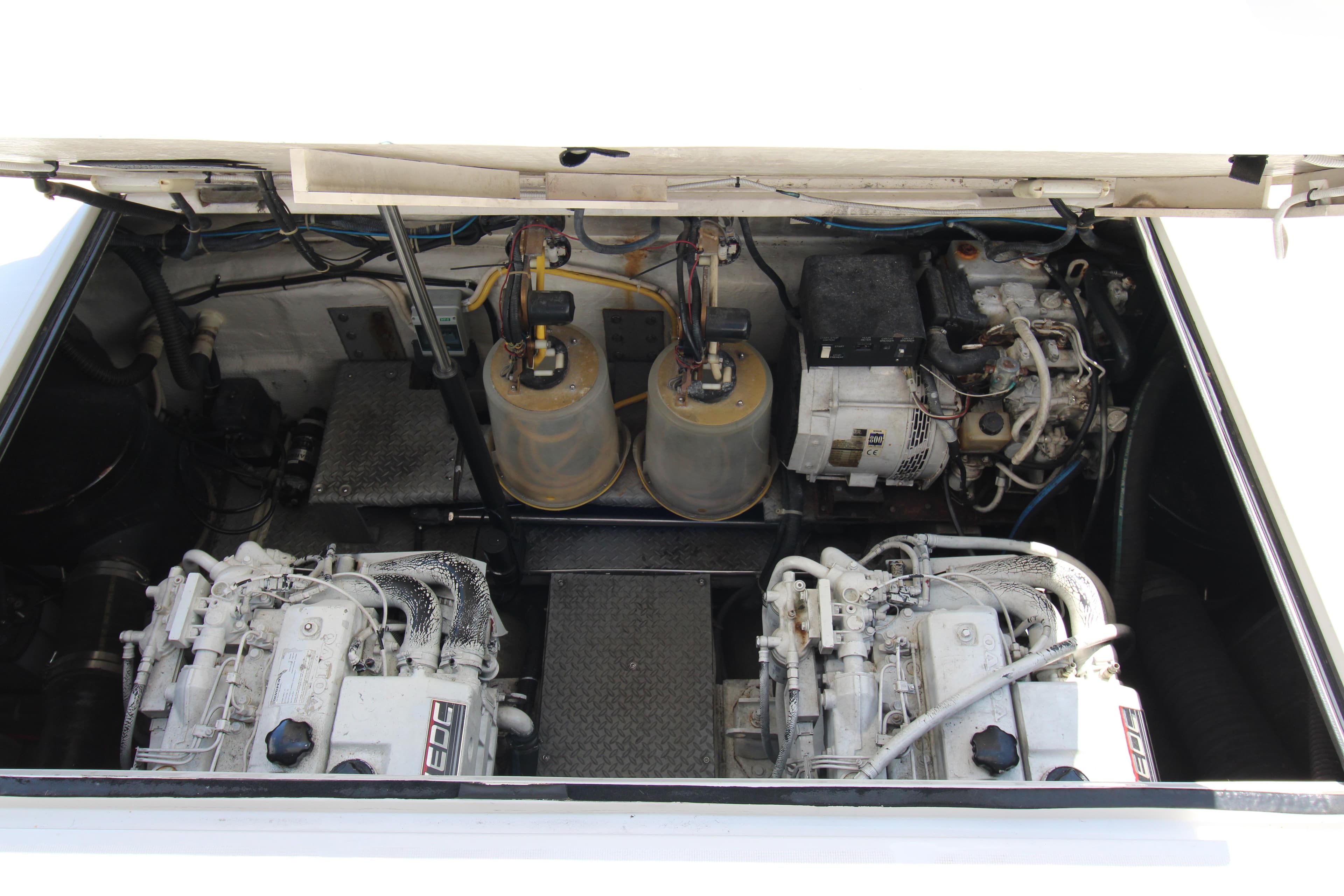Engine compartment of 2002 Regal Commodore 4260 yacht, showcasing dual engines and components.