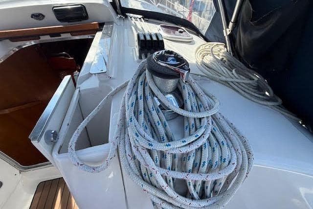 2005 Hunter 38 sailboat deck with winch and coiled ropes.