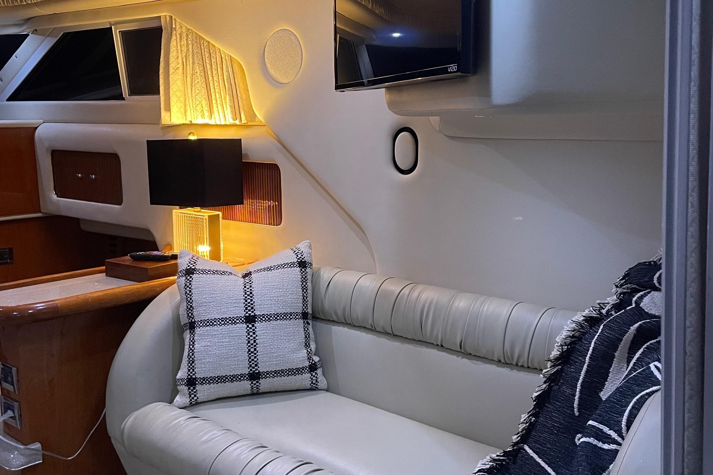 Luxurious interior of 2000 Sea Ray 400 Sedan Bridge with cozy seating and ambient lighting.