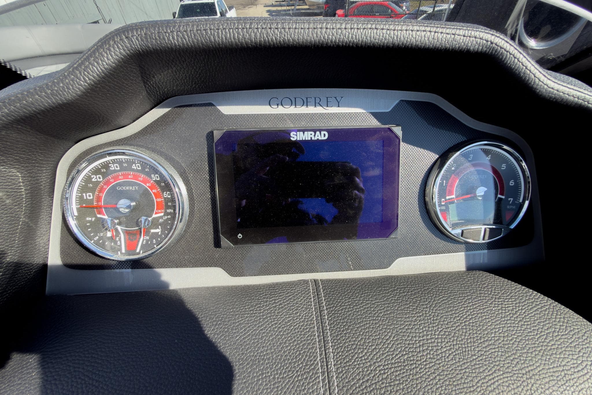 Dashboard of 2026 Godfrey Monaco 235 Split Bench with Simrad display and gauges.
