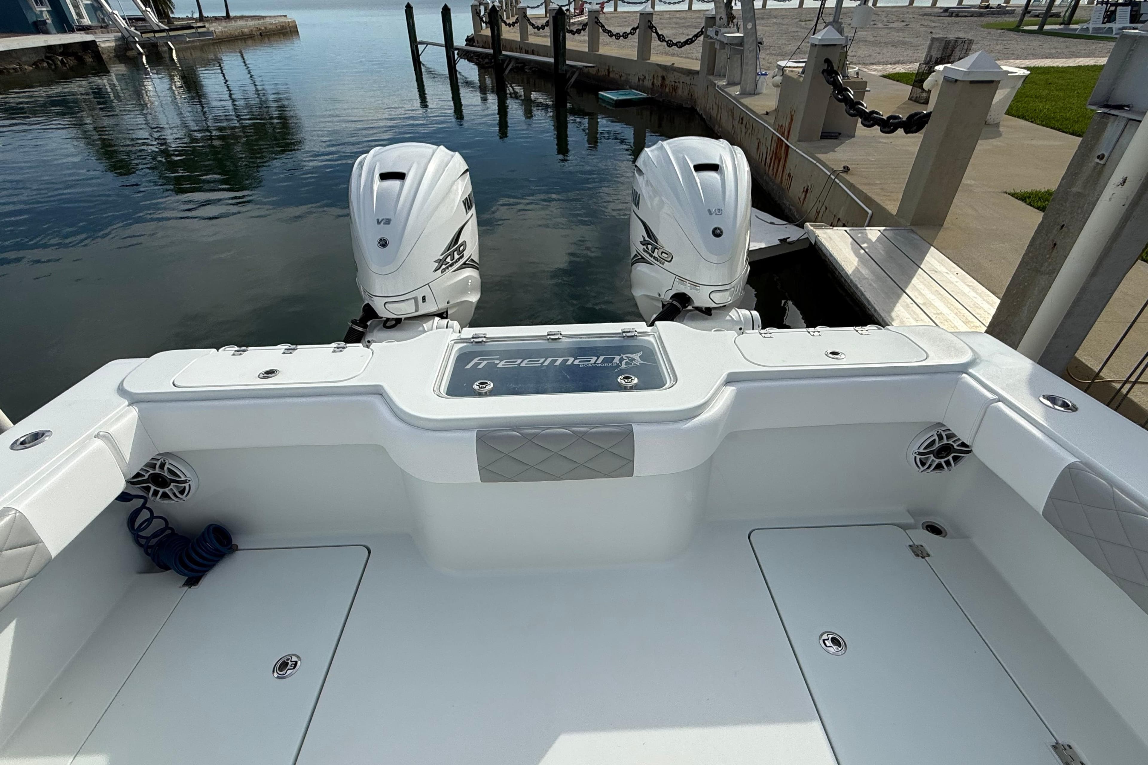 2022 Freeman 34VH boat with twin engines docked at marina.