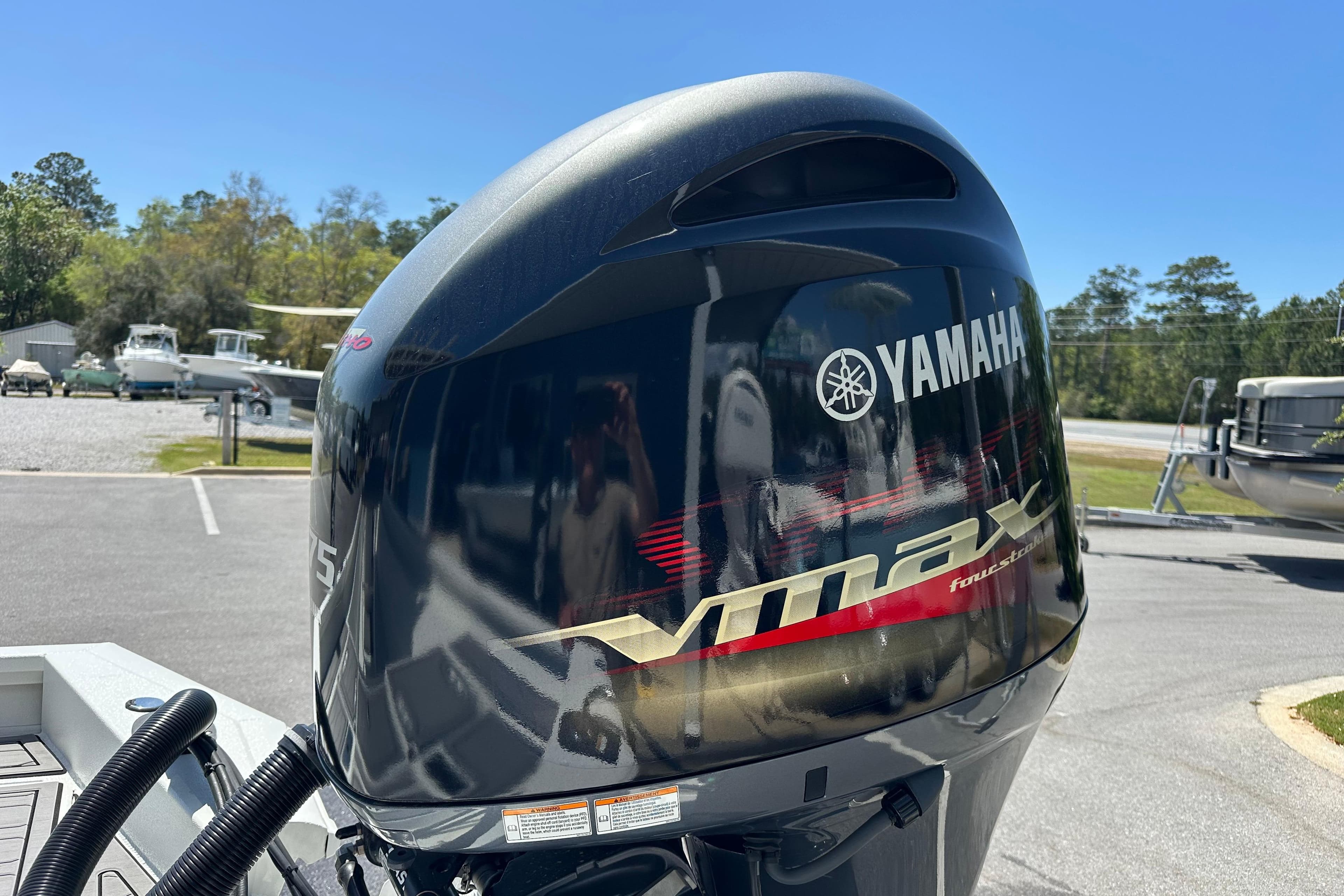 Yamaha VMAX outboard motor on 2024 Avid 23 Mag boat, parked outdoors.