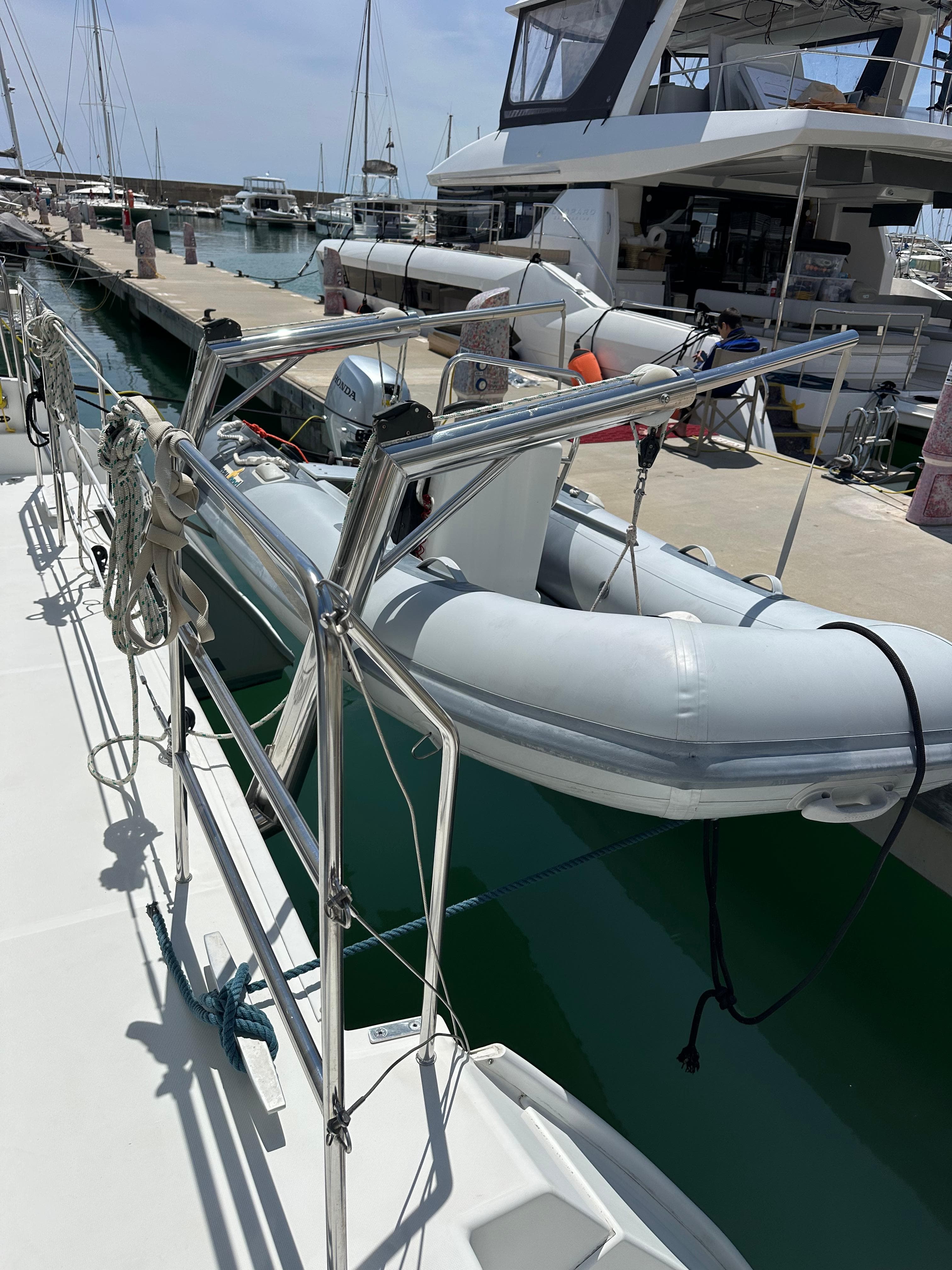 2007 Lagoon 421 yacht docked with inflatable boat on deck.