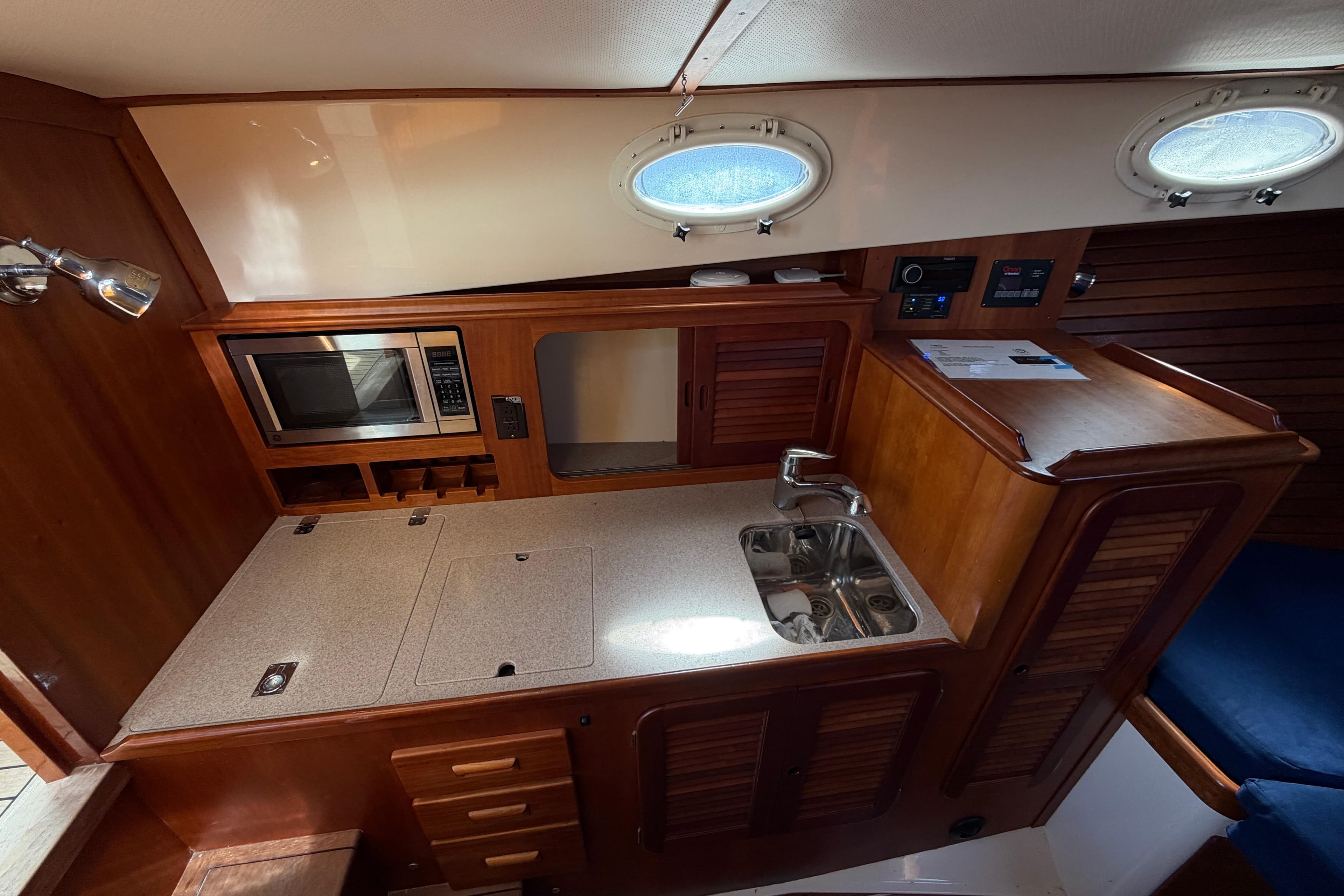 Interior of 2009 Hinckley Picnic Boat 37 MKIII with kitchenette and wooden cabinetry.