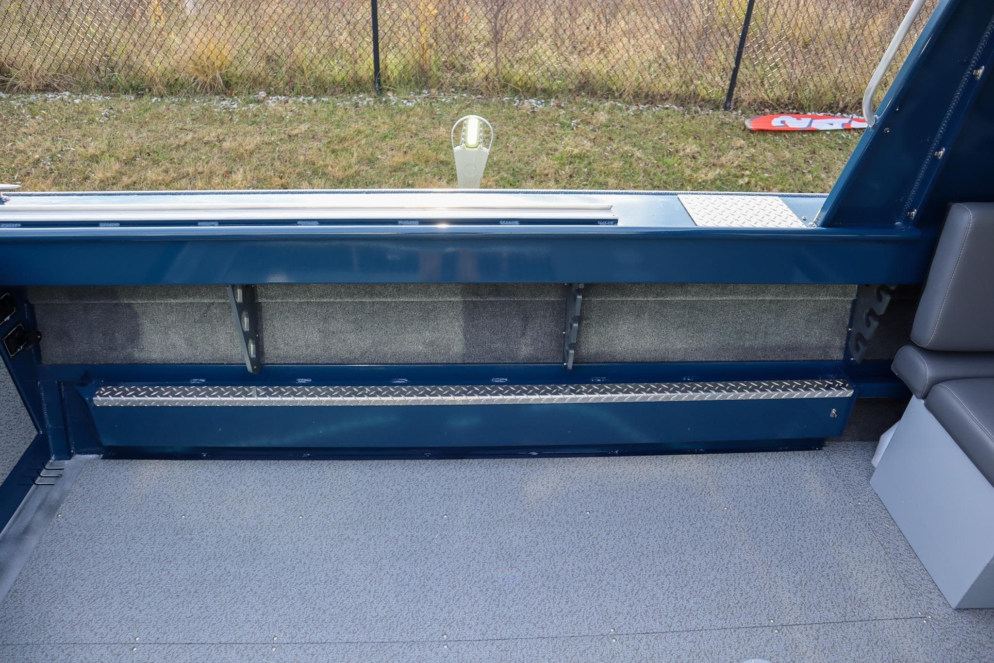Interior view of 2026 Hewescraft 240 Ocean Pro ET HT boat, featuring seating and storage.