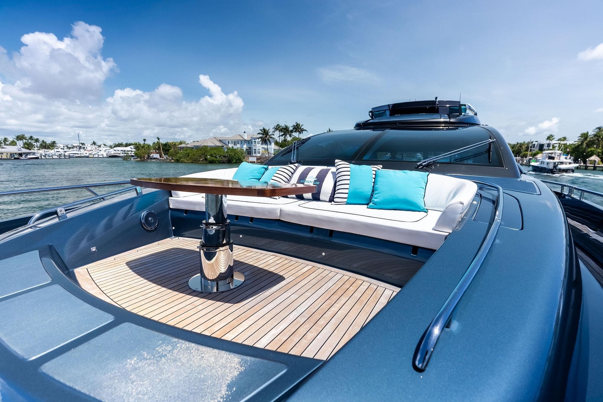 Luxurious 2024 Riva 76 PERSEO Super yacht with elegant deck seating and scenic waterfront view.