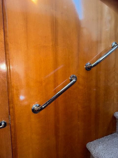 Wooden interior with metal handrails on a 2002 Carver 570 Voyager Pilothouse.