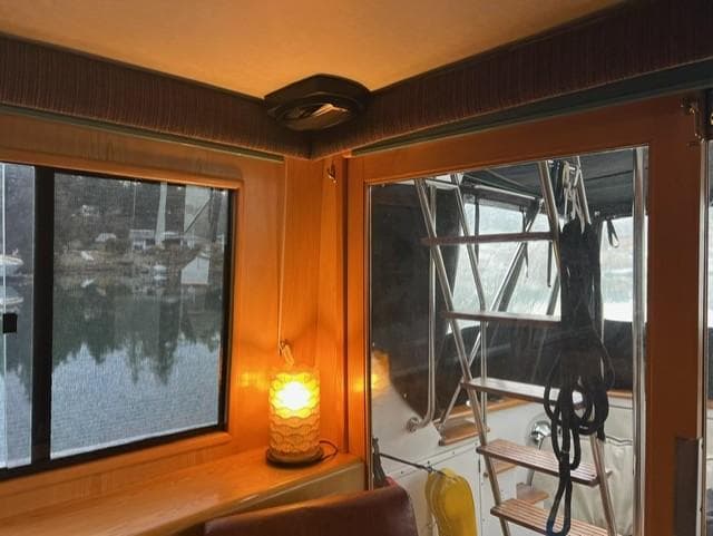 Interior view of 1989 Ocean Alexander 42 yacht with window and cozy lighting.