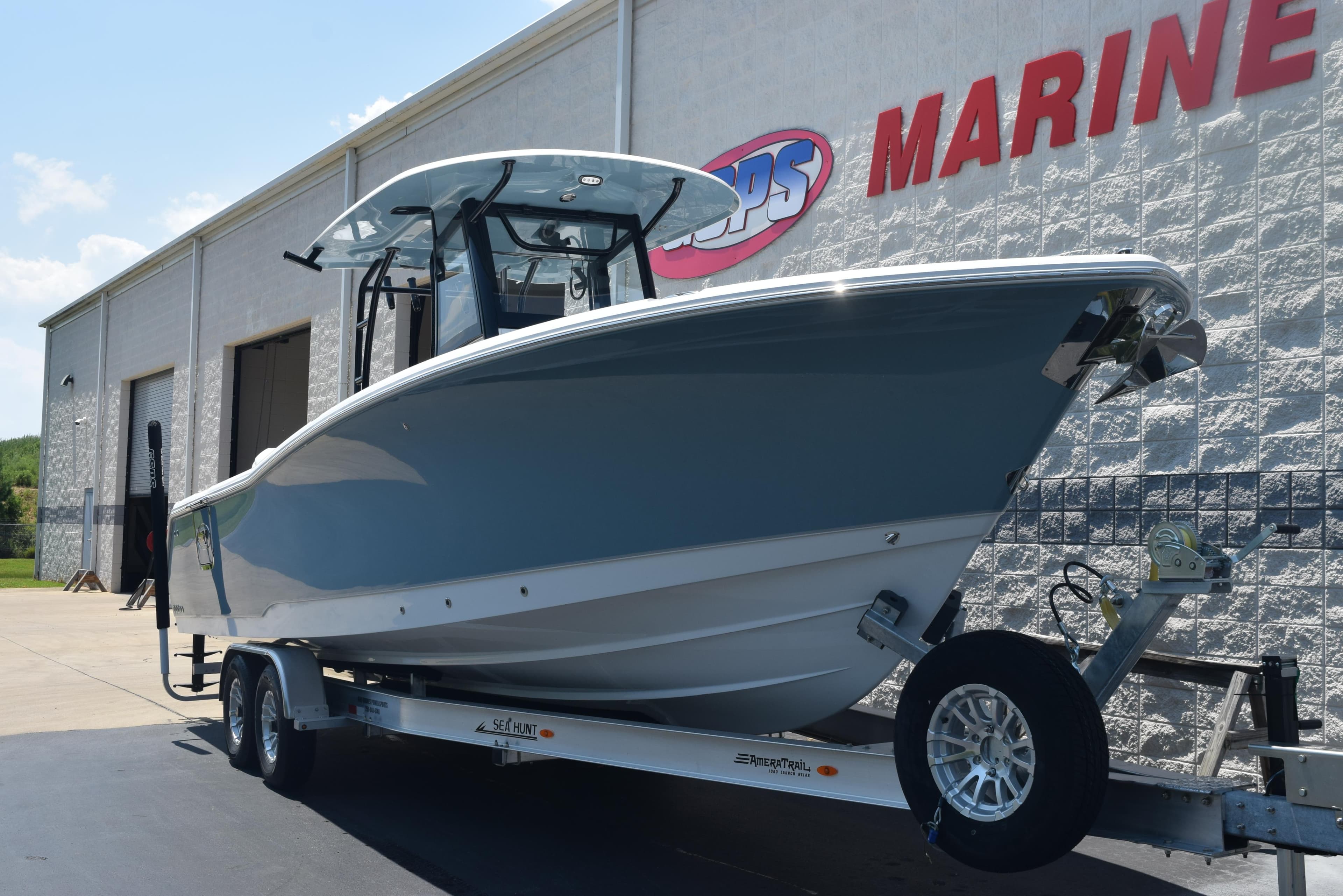 2026 Sea Hunt Gamefish 30 Forward Seating boat on trailer outside marine dealership.