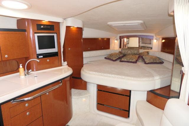 Luxurious interior of 2005 Sea Ray 340 Sundancer with cozy bed and modern amenities.