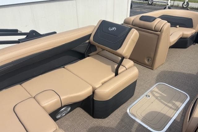 2026 Barletta C22UC boat interior with tan and black seating, showcasing luxury and comfort.