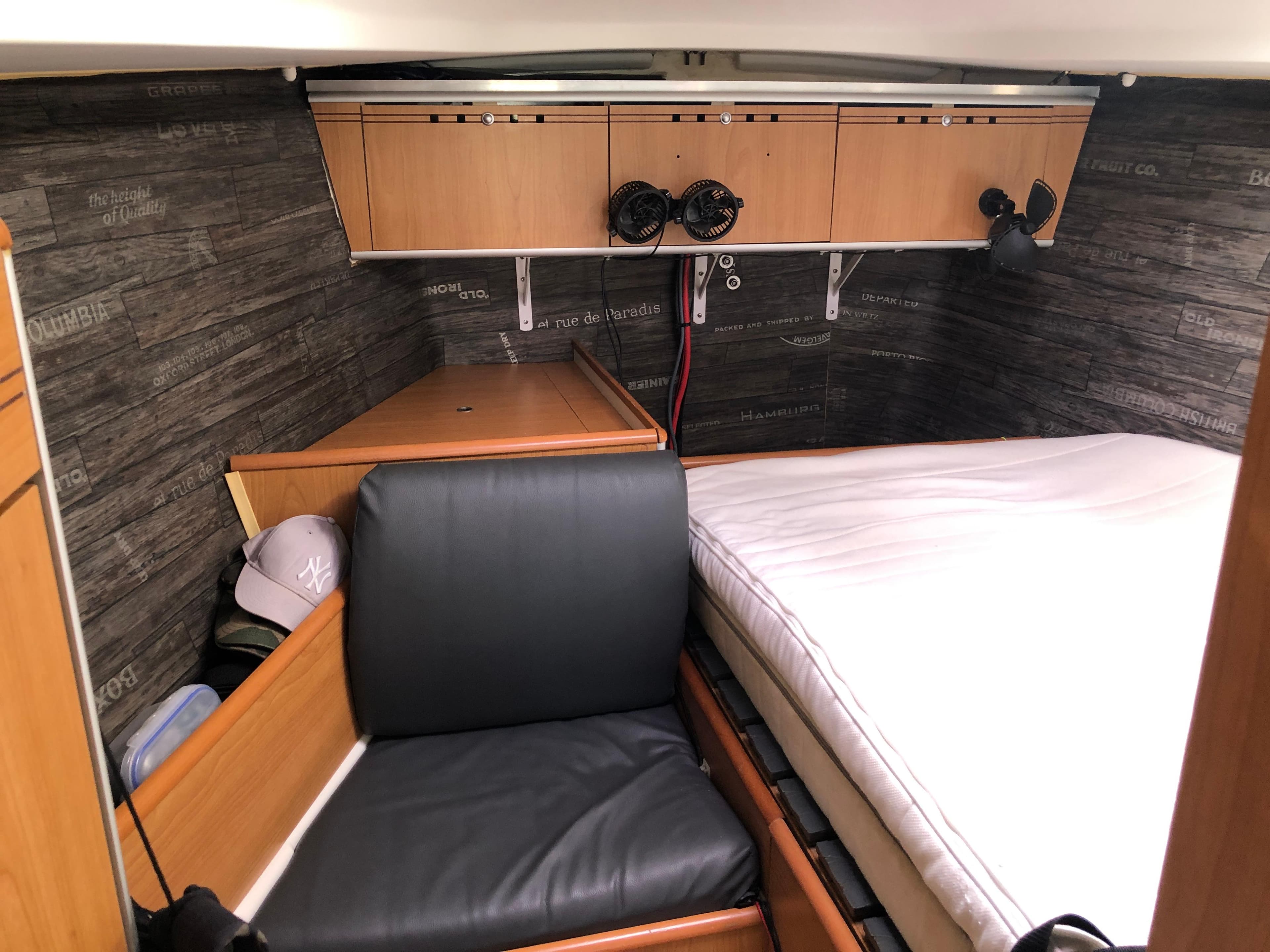 Cozy cabin interior of 2006 Harmony 38 sailboat with wood paneling and comfortable seating.