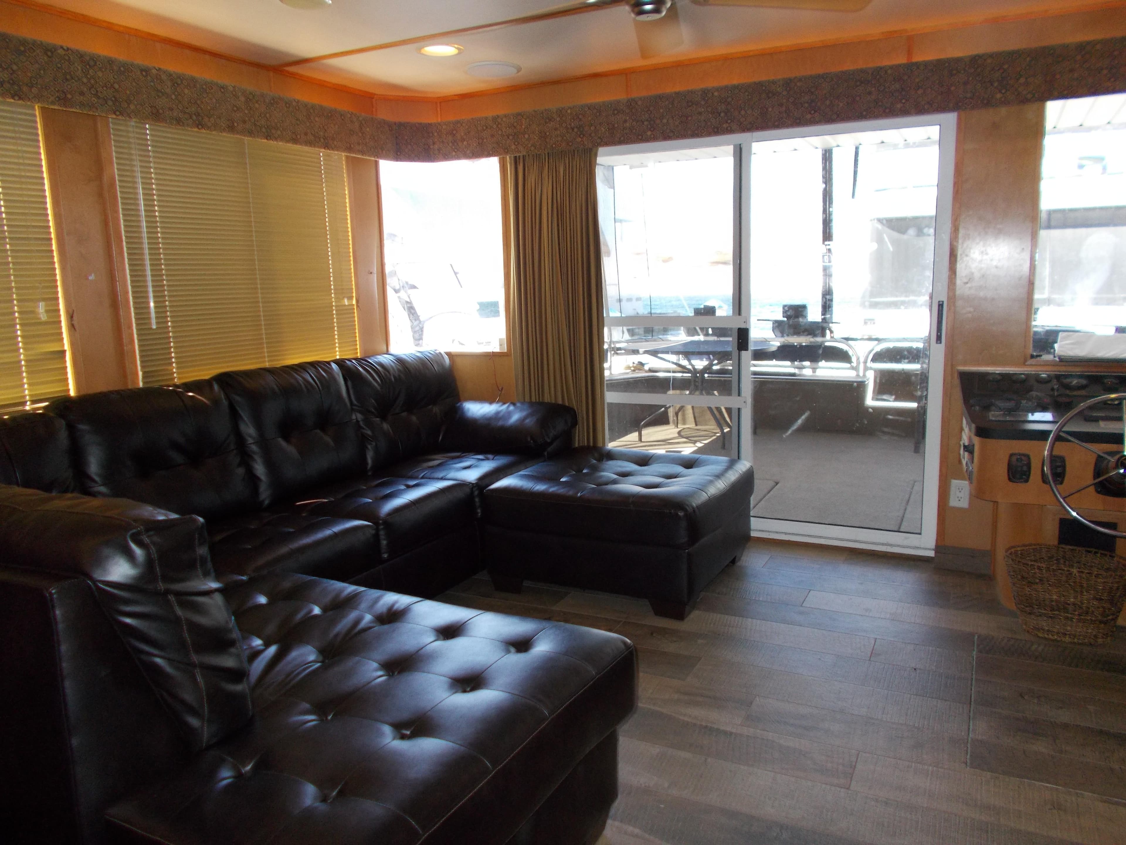 Luxurious 2003 Stardust Cruisers houseboat interior with leather seating and large windows.