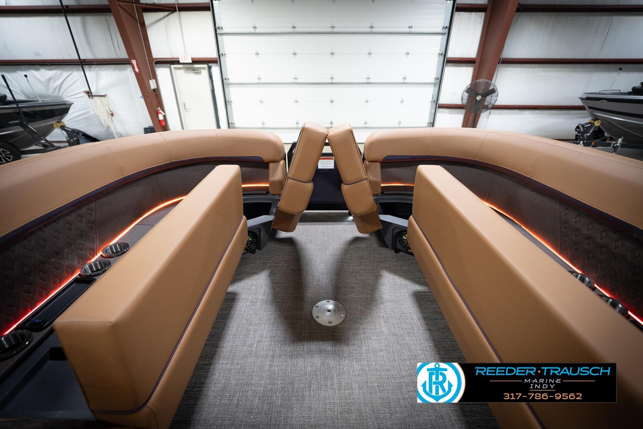 2026 Bennington 22 MFB boat interior with tan seating and ambient lighting.