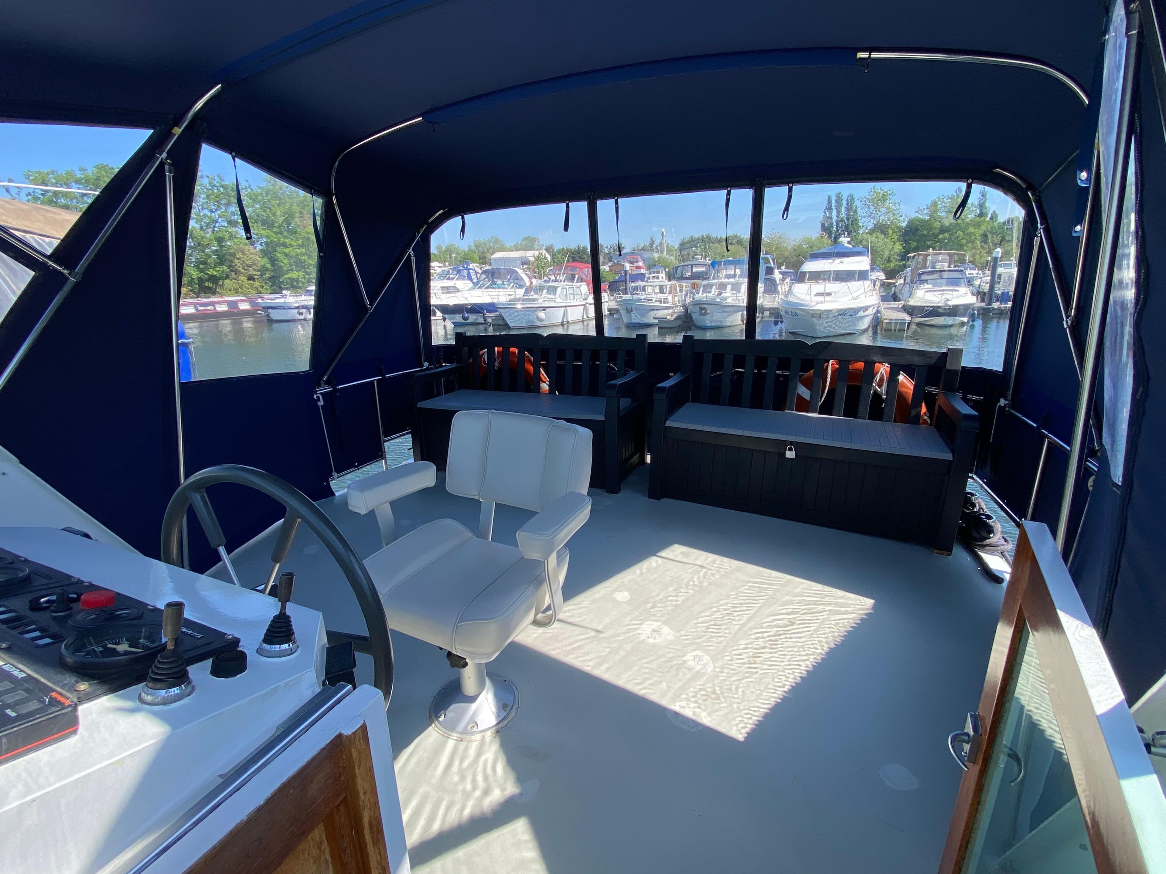 Interior view of 1993 Aquanaut Beauty 1200 AK yacht with seating and helm.