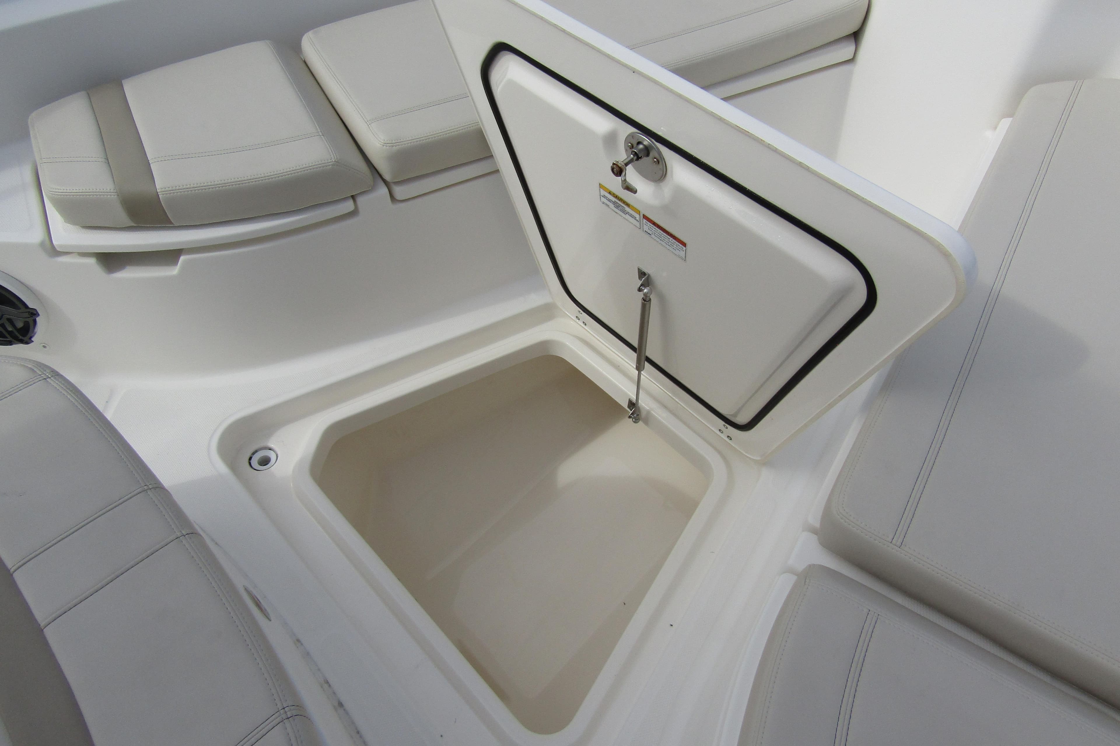 2023 Boston Whaler 280 Dauntless storage compartment with cushioned seating.