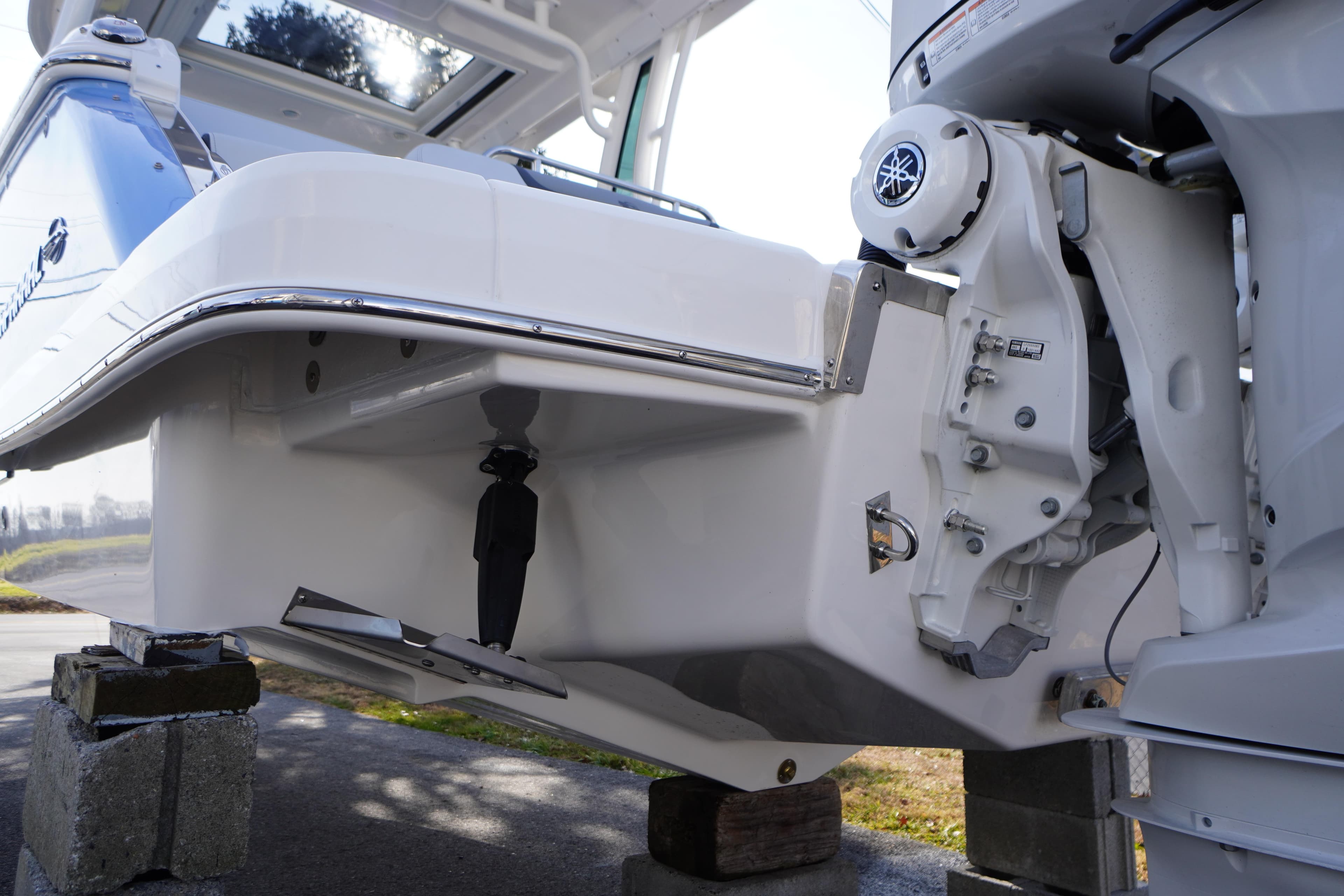 2026 Chaparral 280 OSX boat on blocks, showcasing the engine and hull details.