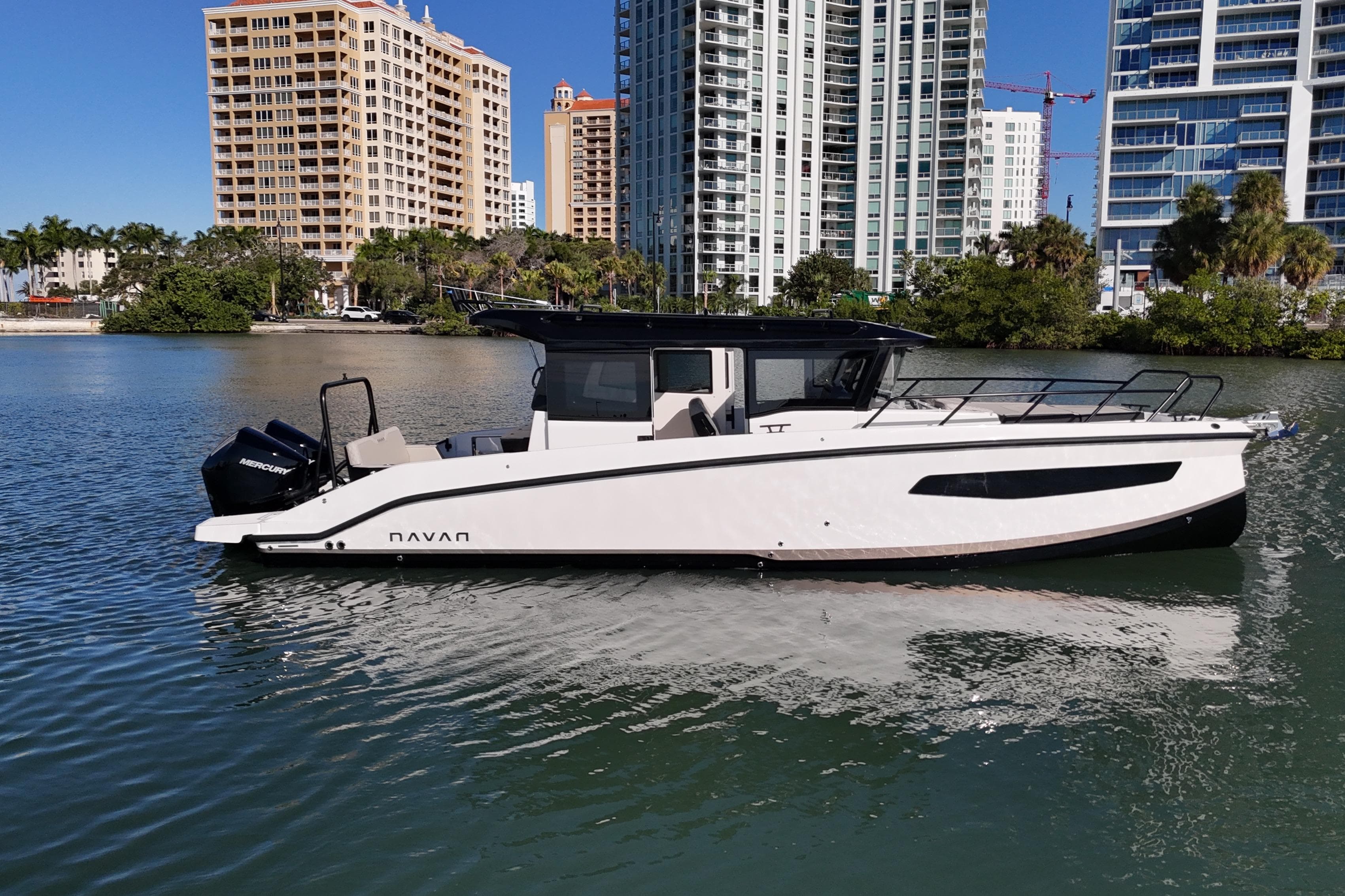 2026 Navan C30 boat on water with city skyline background.