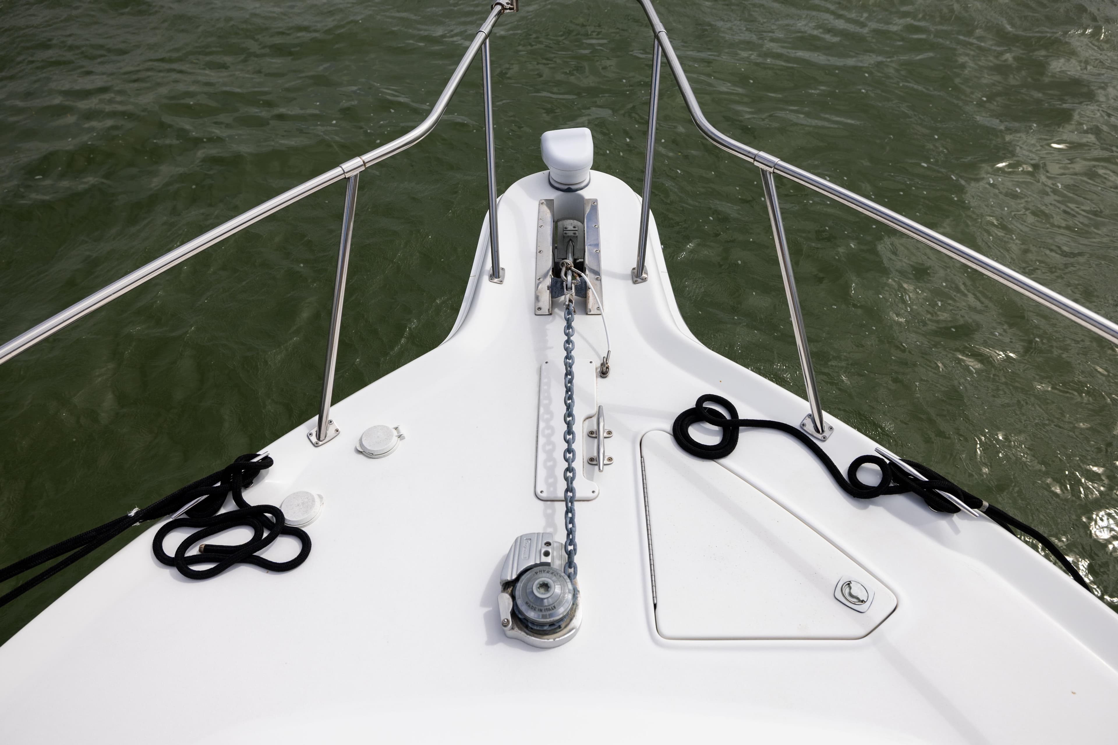 Bow of 2000 Sea Ray 370 Express Cruiser with anchor chain and ropes.