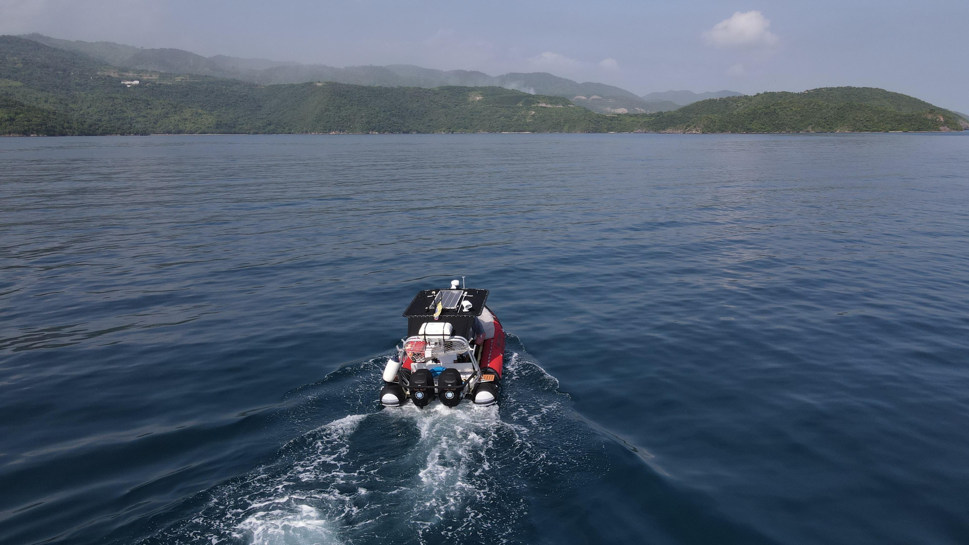 AB Inflatables Oceanus 24 VST 2010 boat cruising on calm waters with scenic island backdrop.