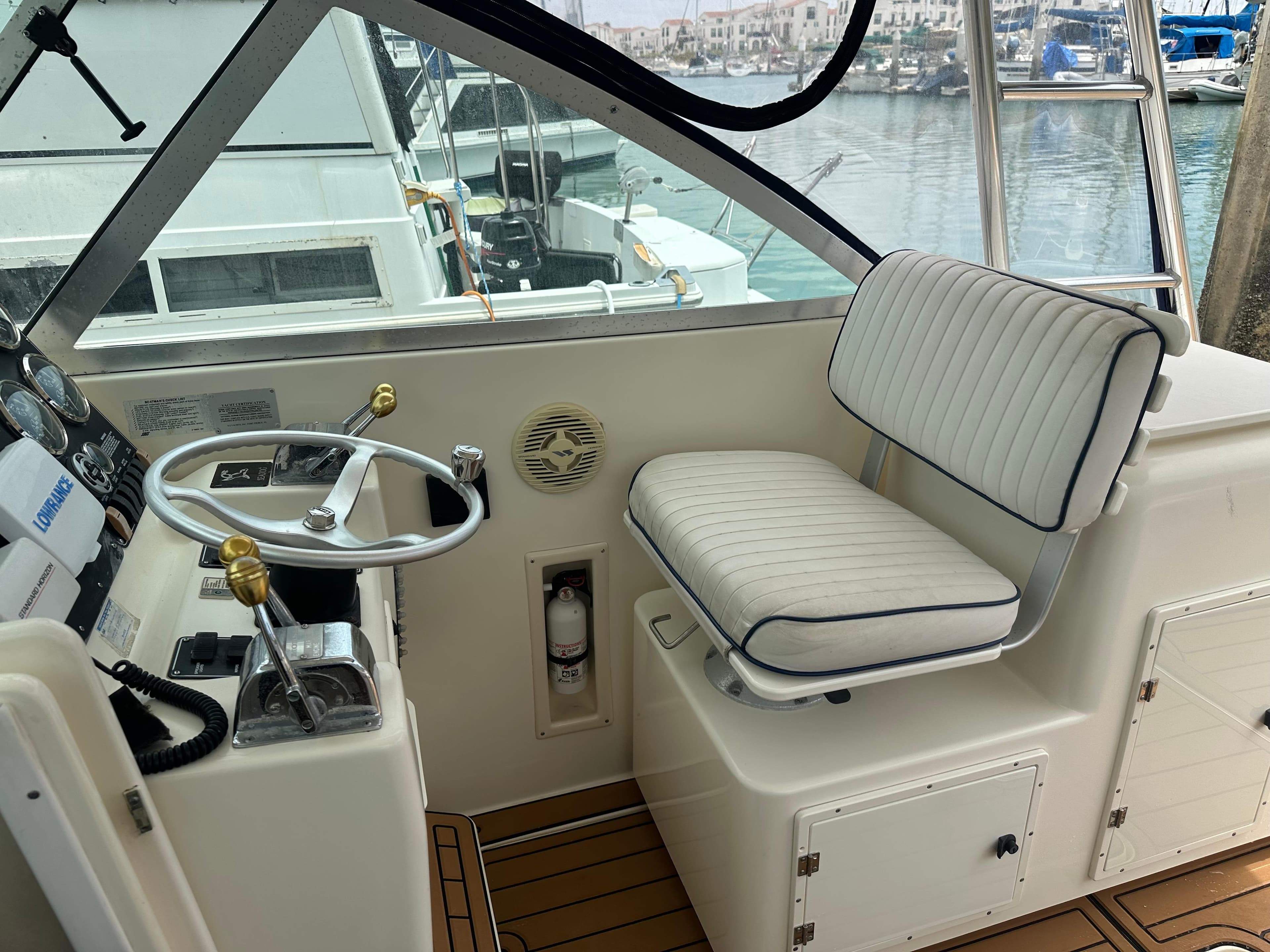 Interior of a 2000 Pursuit 3000 Express boat with steering wheel and seat.