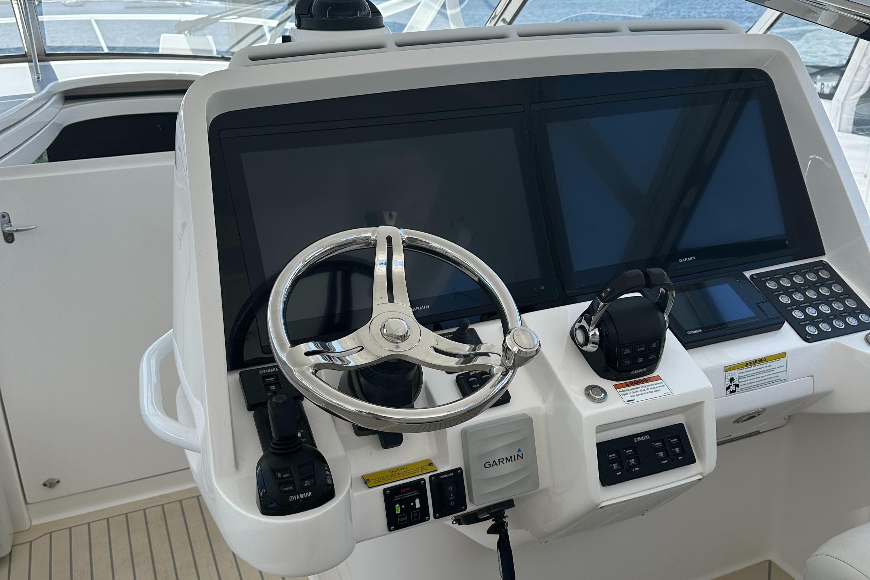Helm of 2020 Intrepid 475 Sport Yacht with Garmin displays and steering wheel.