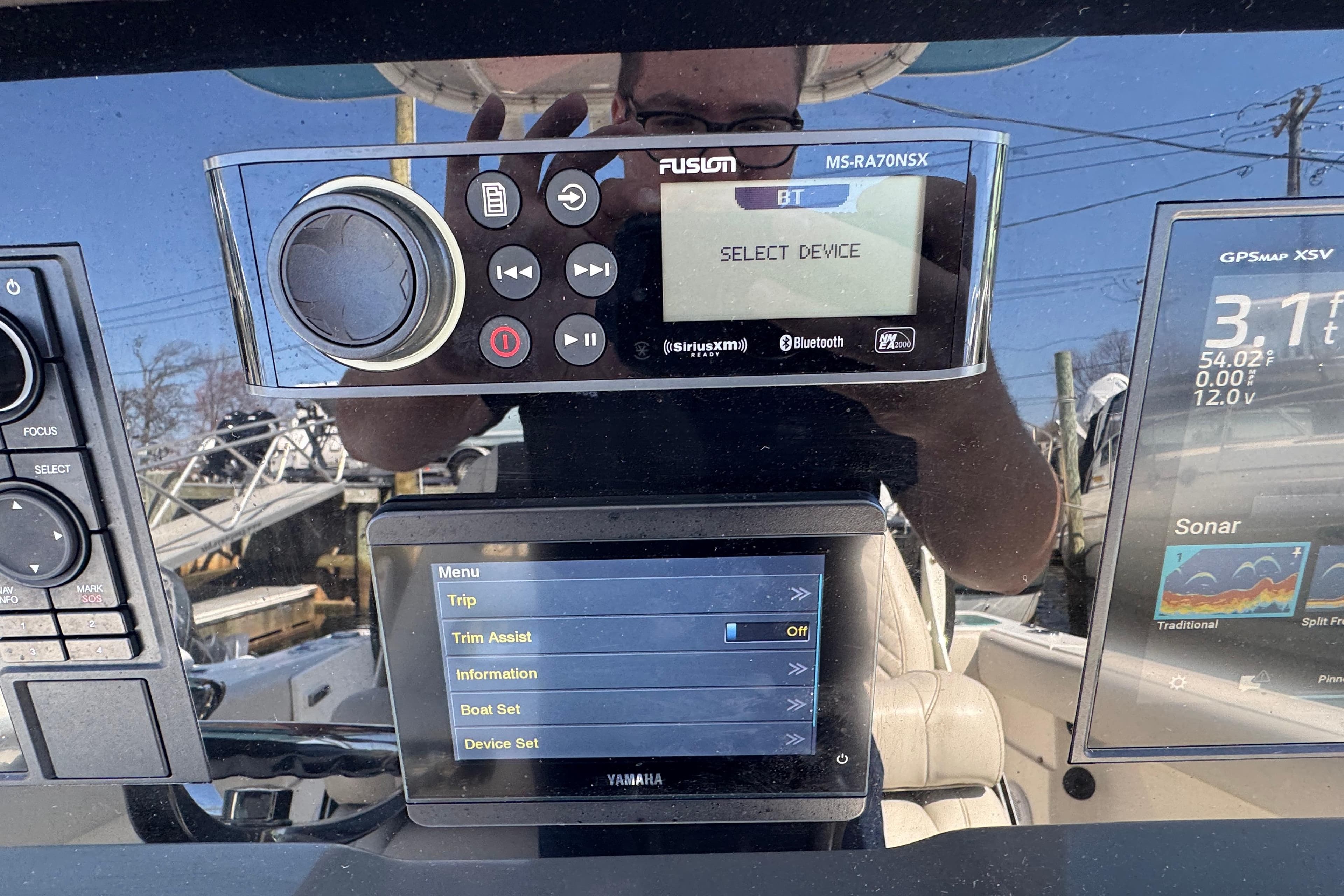 Control panel of a 2022 Sailfish 242 CC boat with navigation and audio systems.