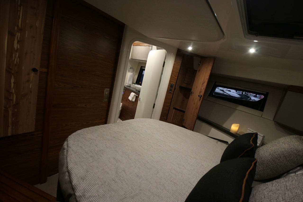 Manufacturer Provided Image: Luxurious interior of 2026 Boston Whaler 405 Conquest, featuring cozy bedding and modern amenities.