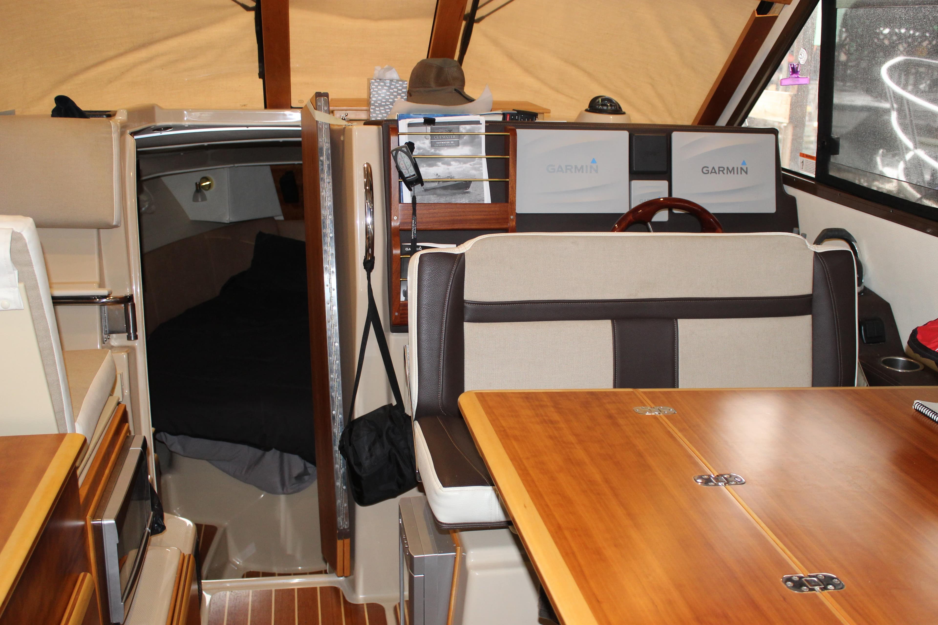 Interior of 2016 Cutwater 30 Command Bridge with wood accents and Garmin navigation.