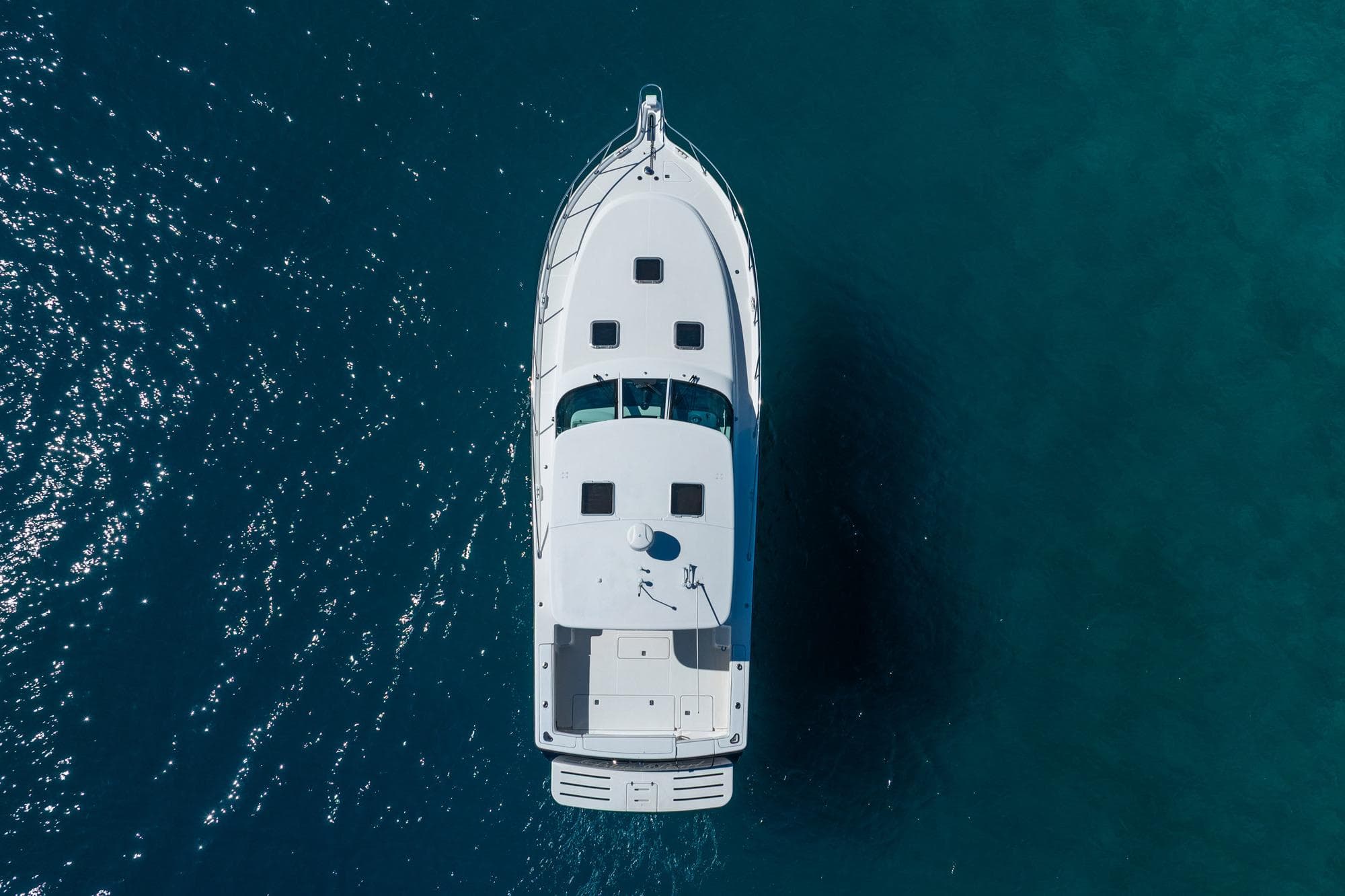 Aerial view of 2004 Tiara Yachts 4200 Open on clear blue water.