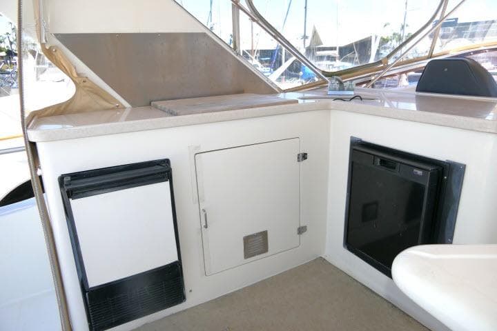 Interior view of a 1999 Hampton 490 Pilothouse yacht, featuring a compact kitchenette area.