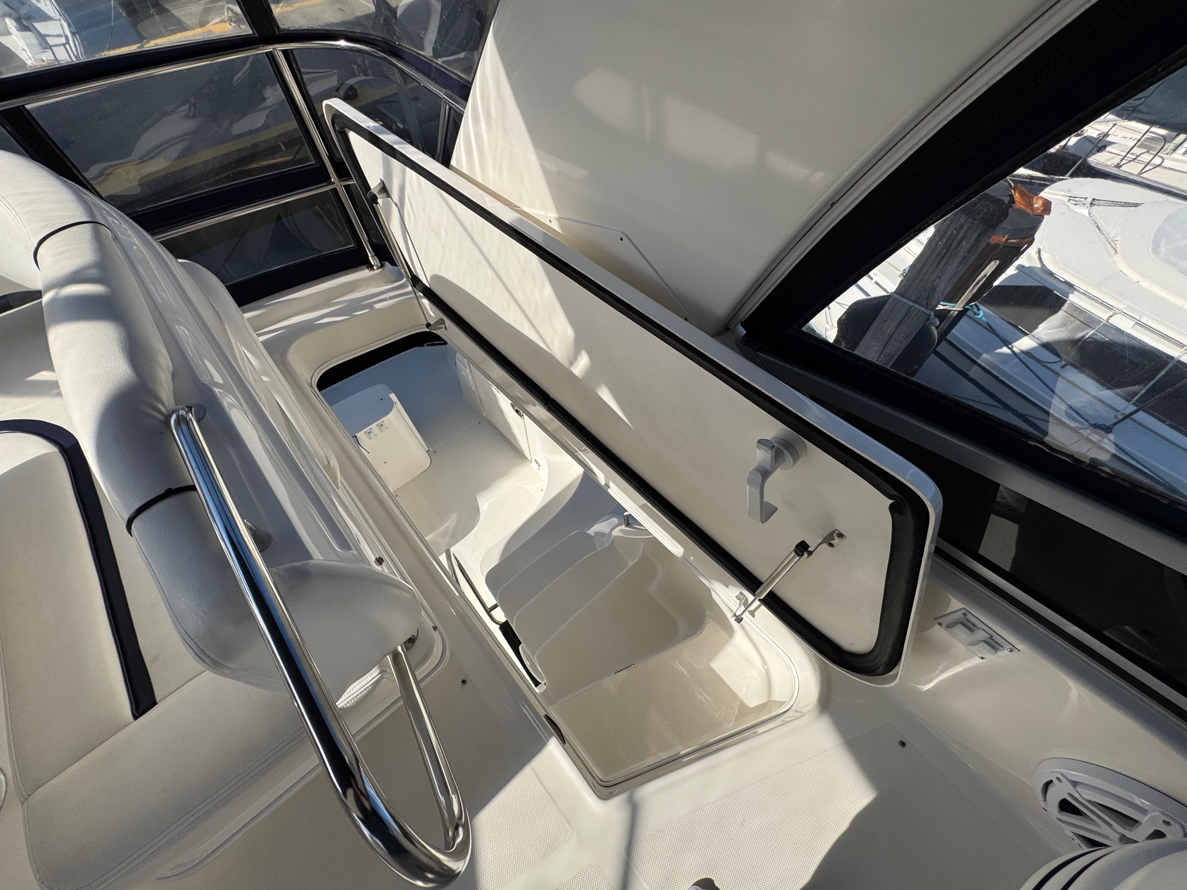 2007 Sea Ray 44 Sedan Bridge interior with seating and storage compartment.